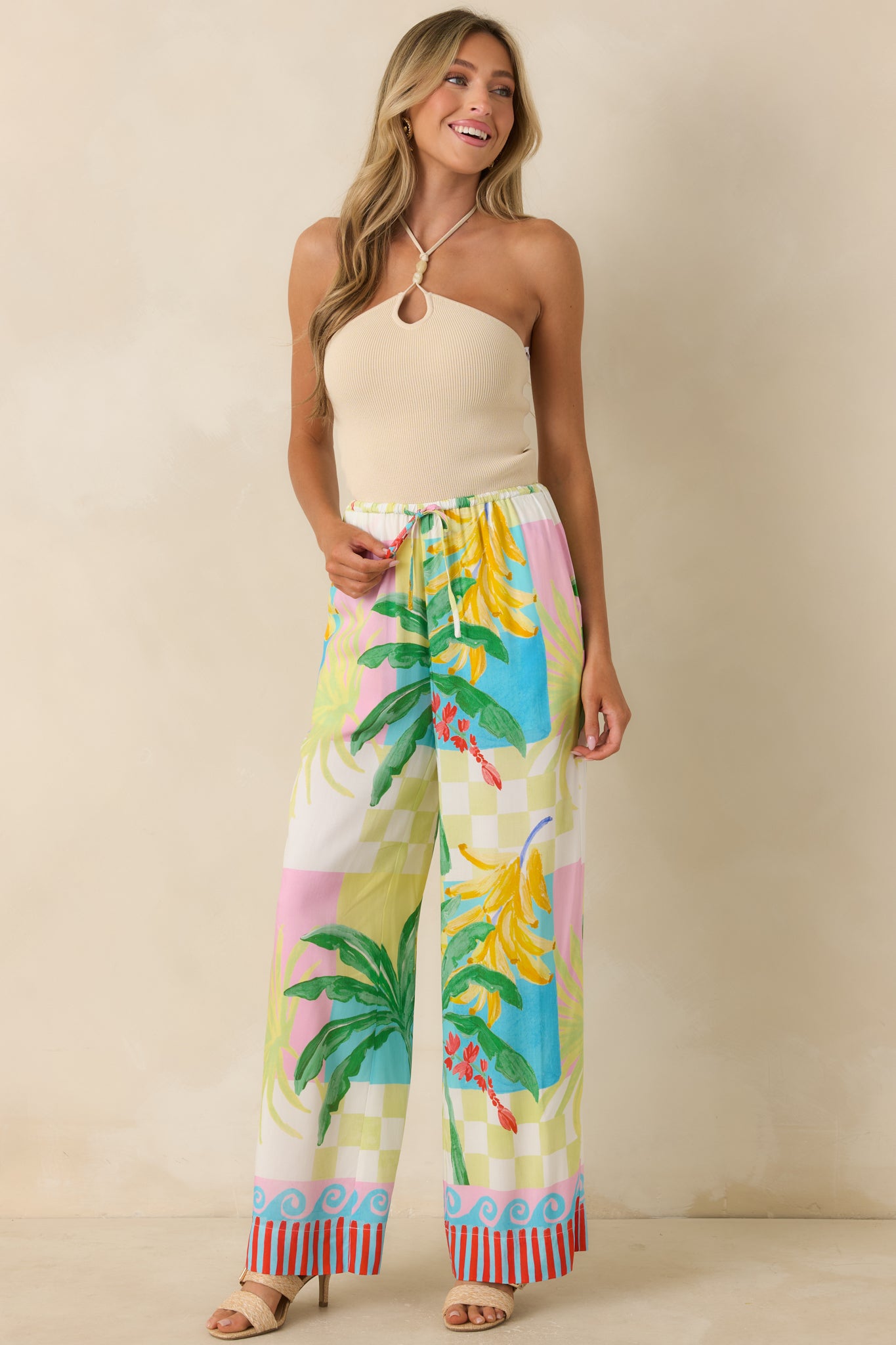 Bold printed wide-leg pants with an elastic waistband, relaxed shape, and eye-catching tropical artwork throughout.