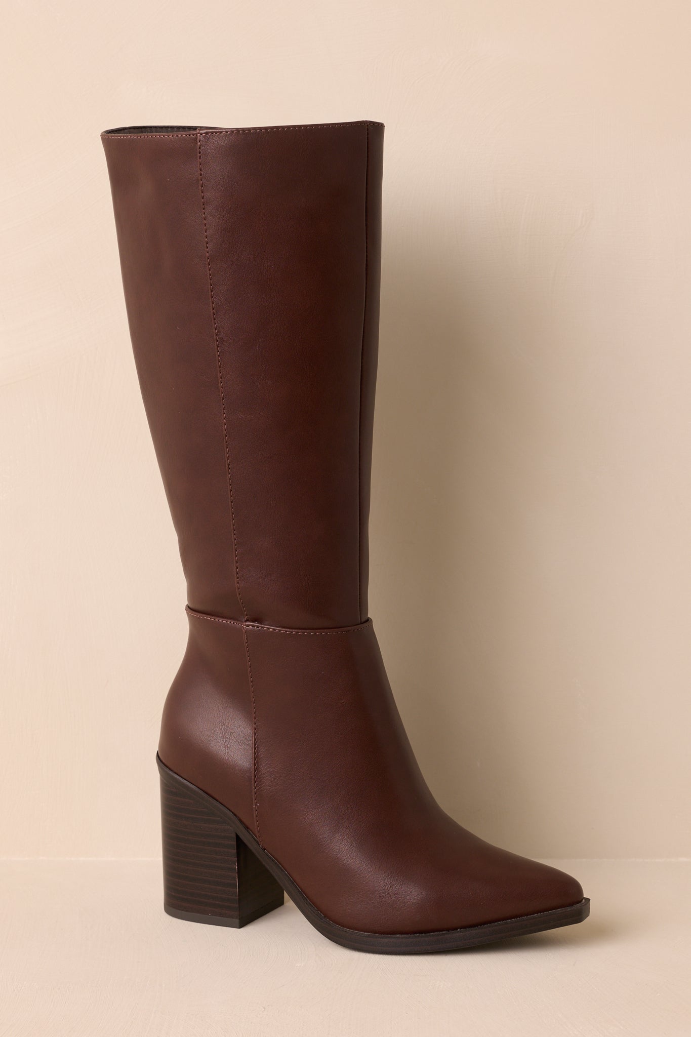 Side view highlighting structured shaft, paneled design, and stacked block heel.