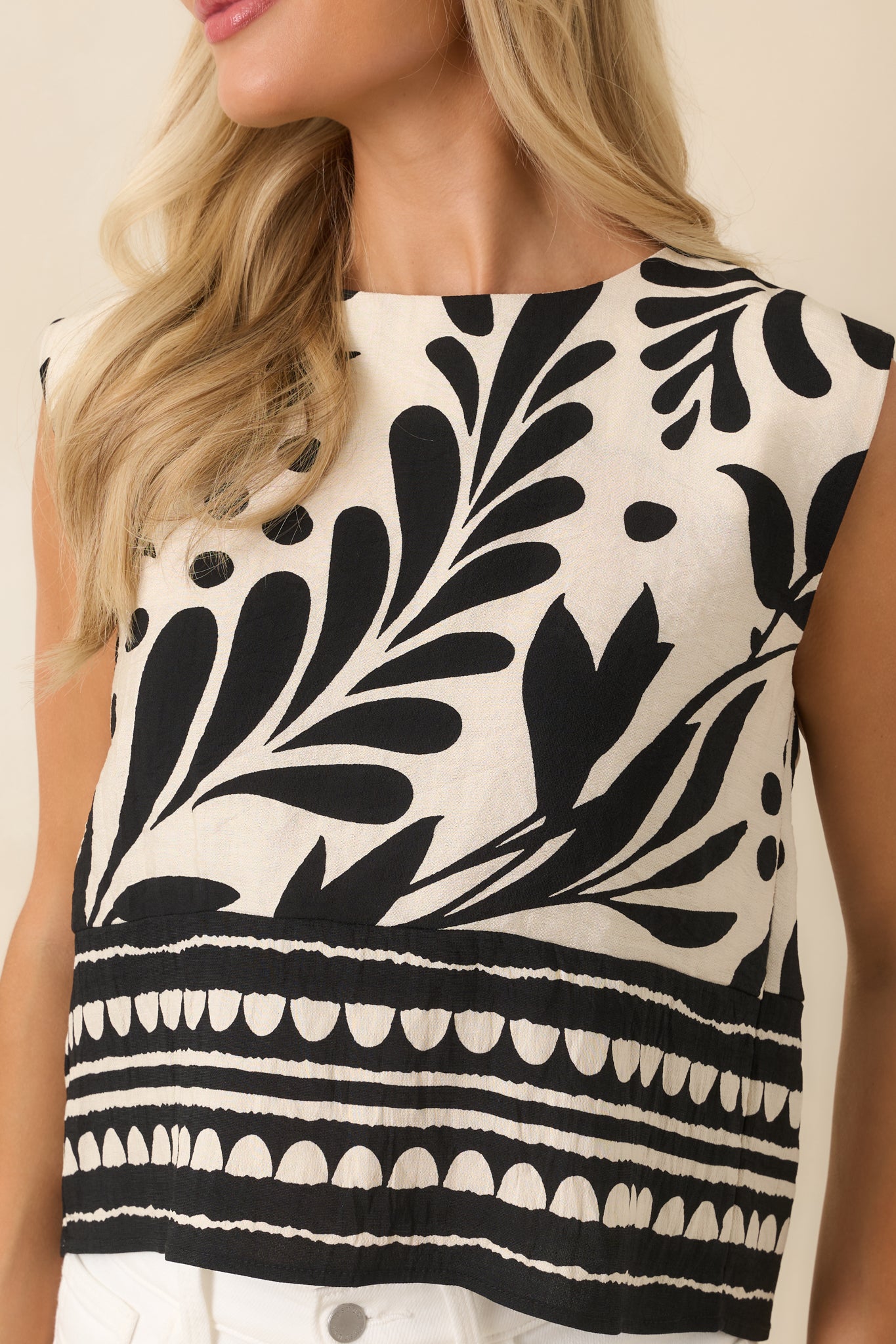 Detailed view of the oversized botanical print, woven texture, border hem design, and decorative button accents.