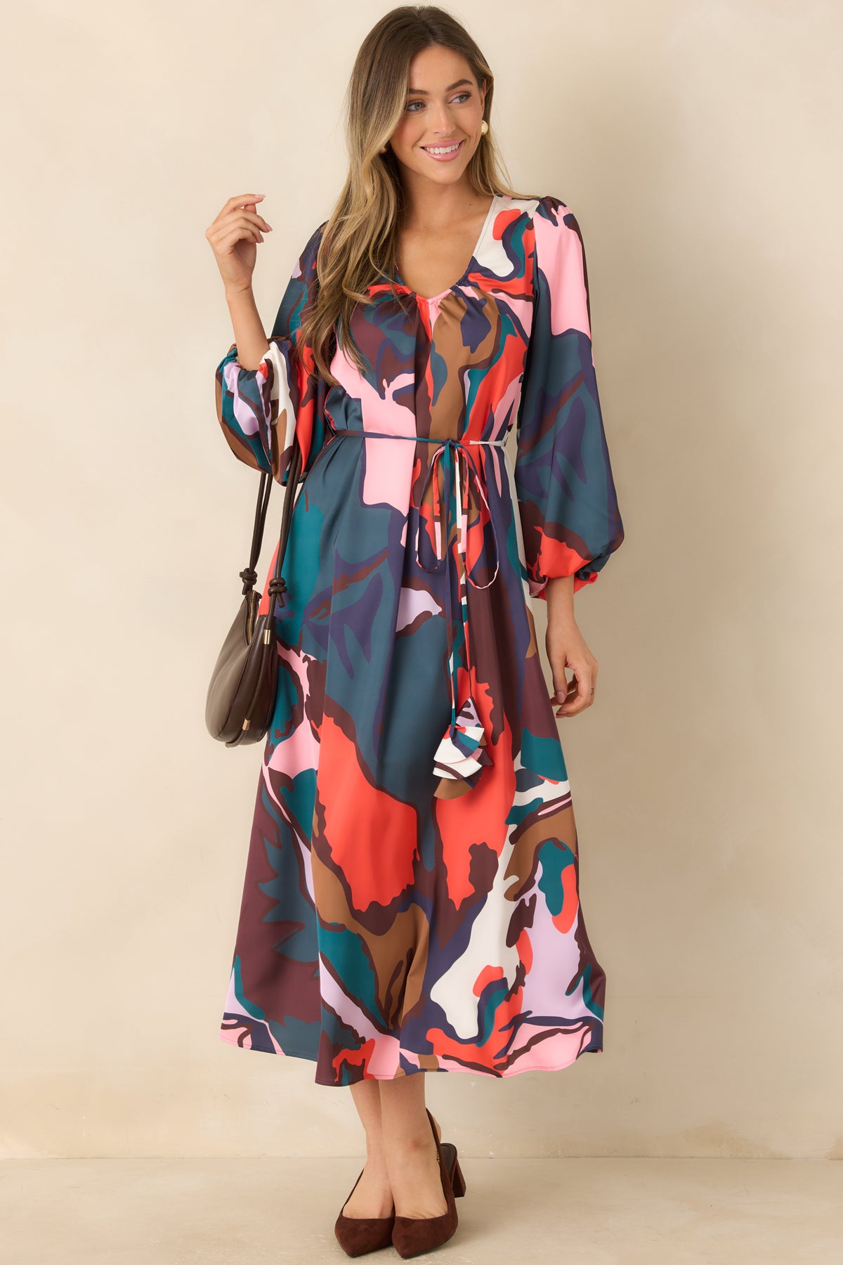 Colorful botanical midi dress featuring a gathered V-neckline, three-quarter sleeves, and a removable tassel tie belt.