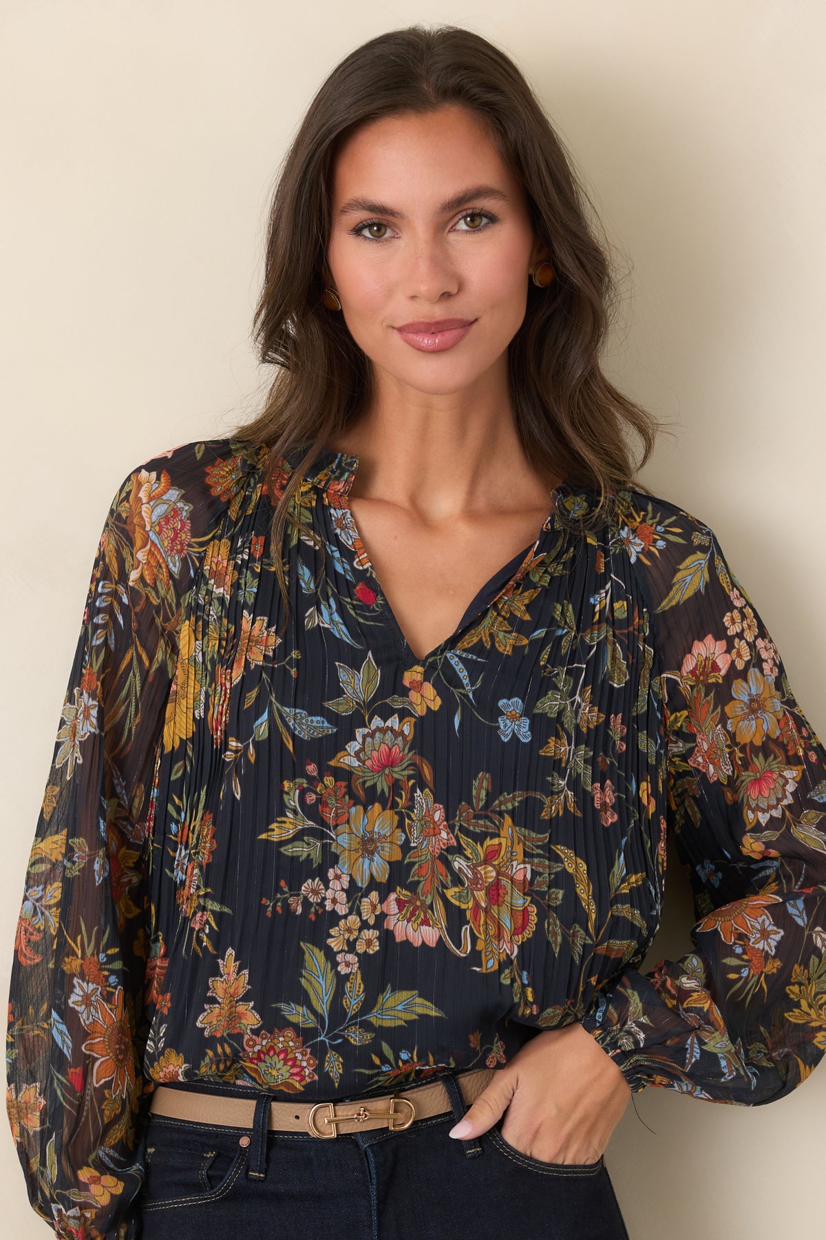 Botanical top highlighting the split V-neckline framed by softly gathered ruffle detailing.