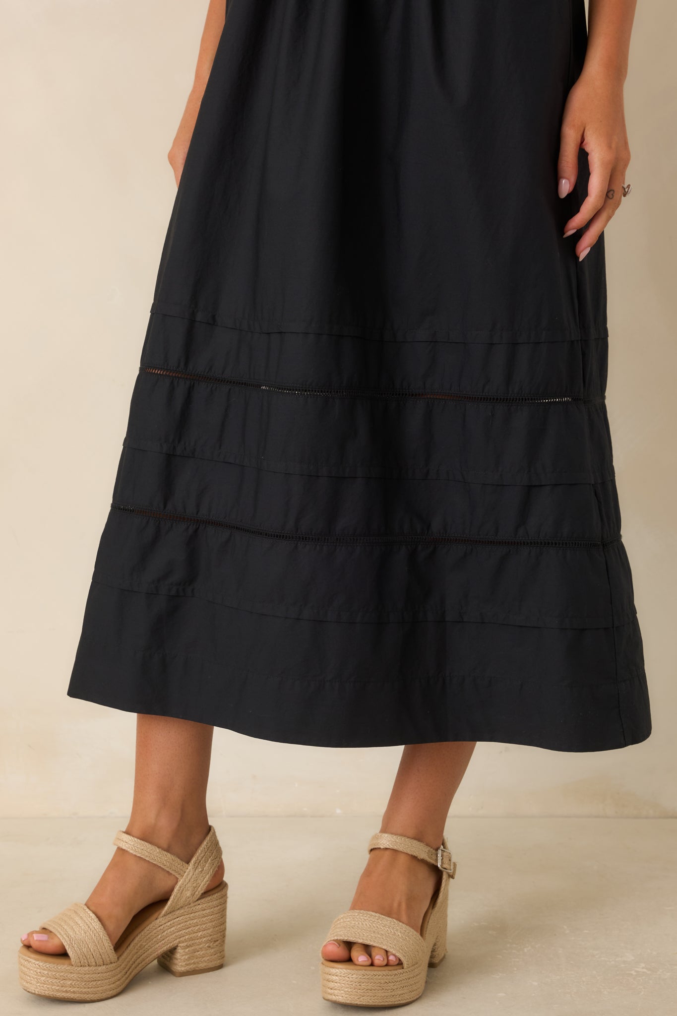 Close-up detail of the gathered cotton poplin skirt and horizontal inset panels along the bottom hem of the dress.