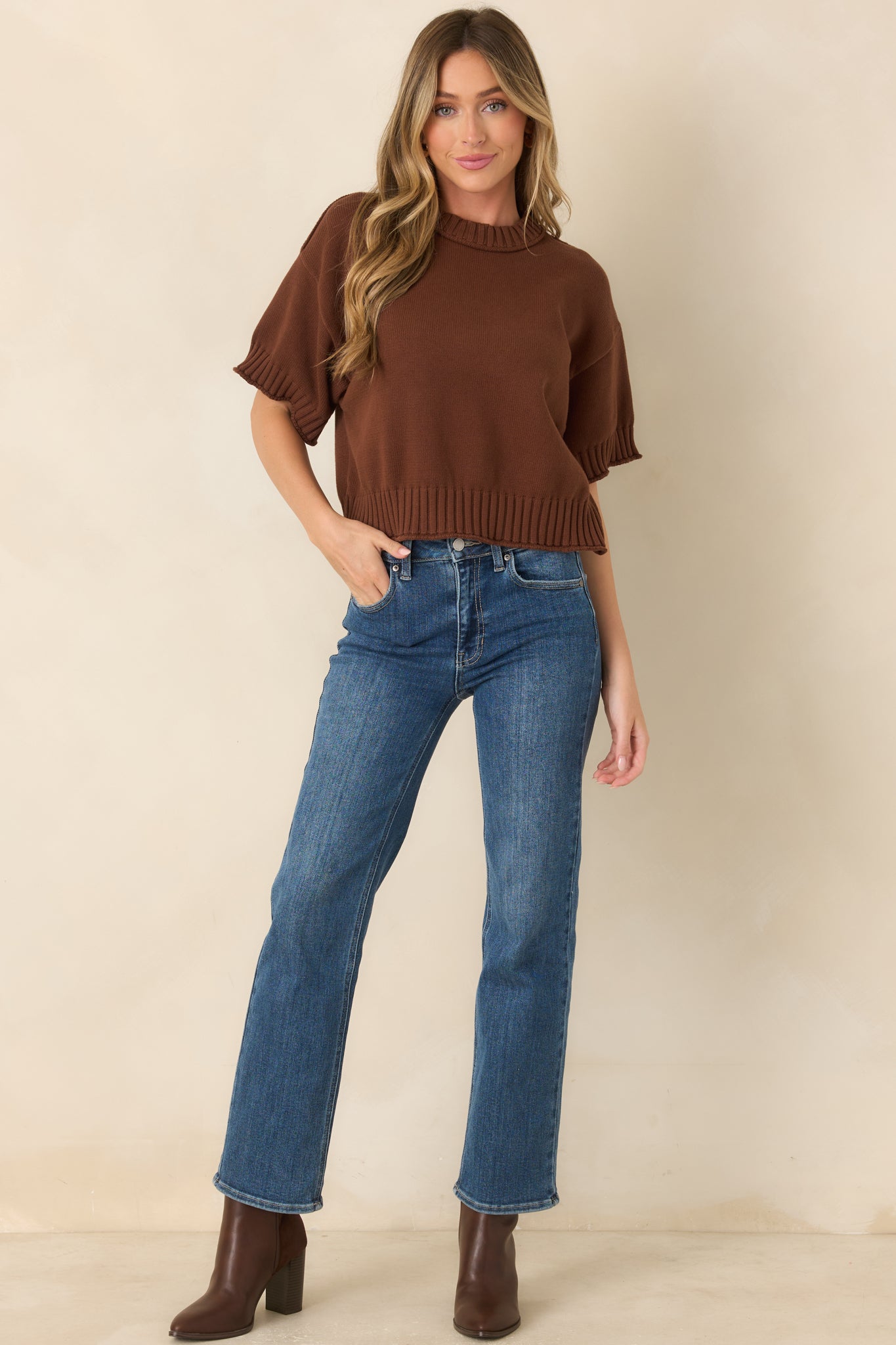 100% cotton top showcasing a slightly boxy silhouette with relaxed sleeves and substantial ribbed detailing along the neckline, cuffs, and hem.