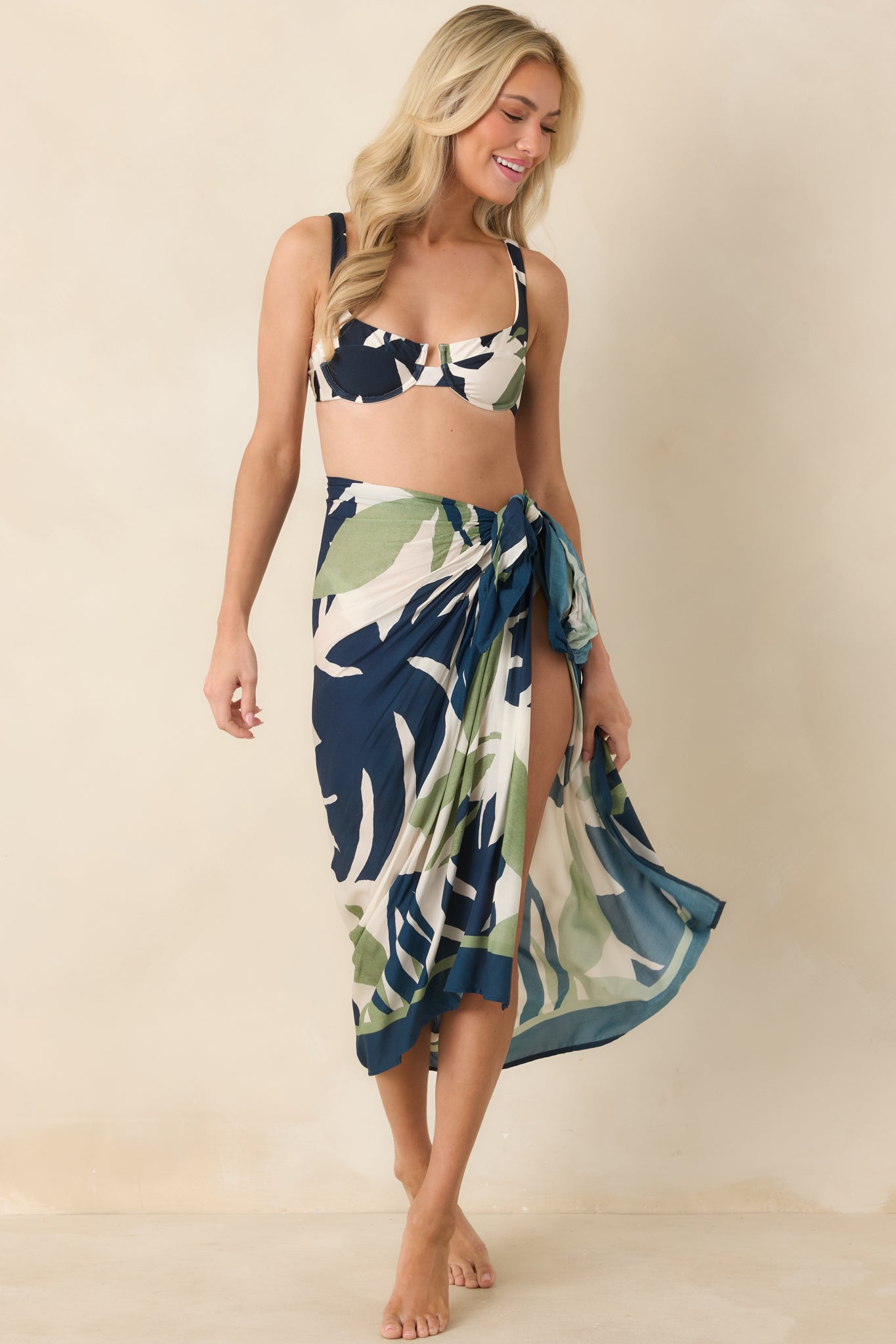 Bra-style bikini top with underwire cups featuring navy, green, and ivory palm leaf print.