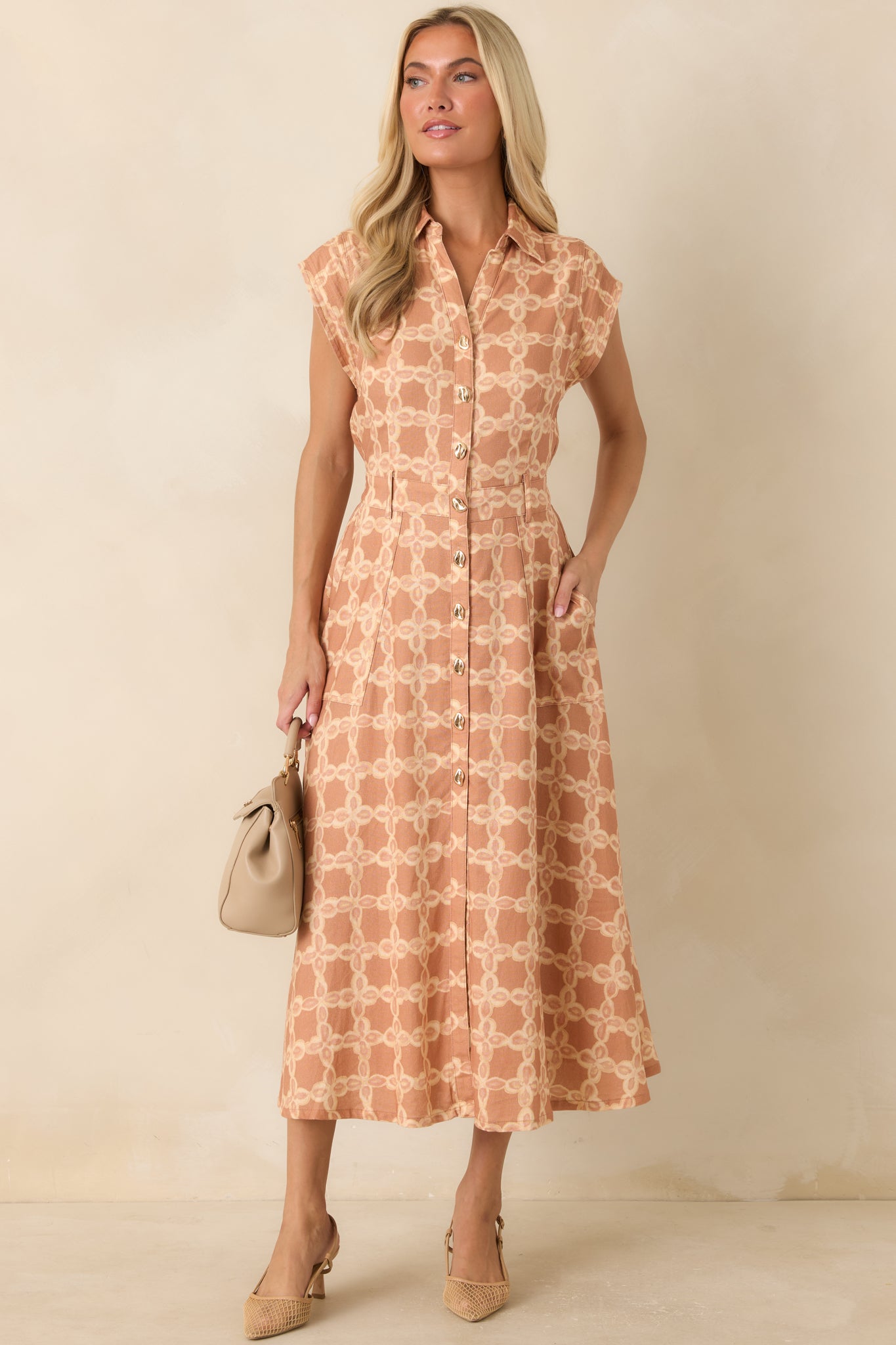 Breathable midi dress with a collared neckline, polished gold-tone buttons, and a flattering elastic waistband.