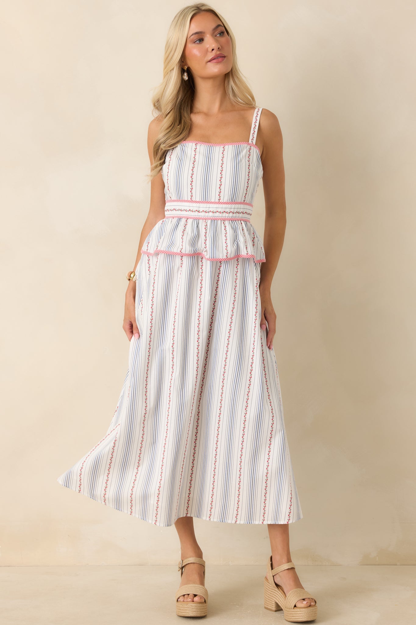 Breathable cotton floral midi dress with a lined construction, adjustable straps, square neckline, and graceful full skirt.