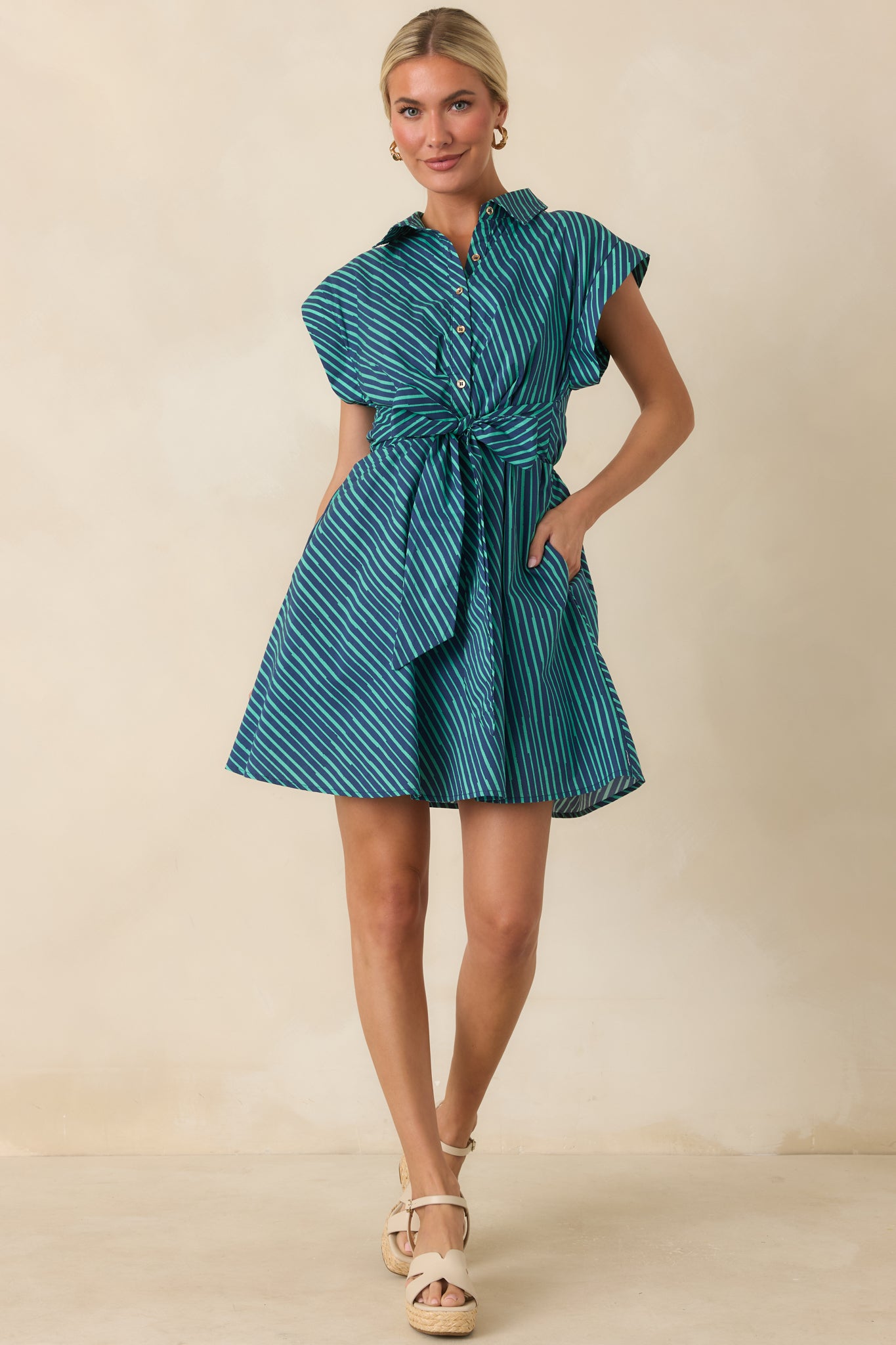 Breathable cotton mini dress designed with cap sleeves, a button-front design, and an easy everyday silhouette.