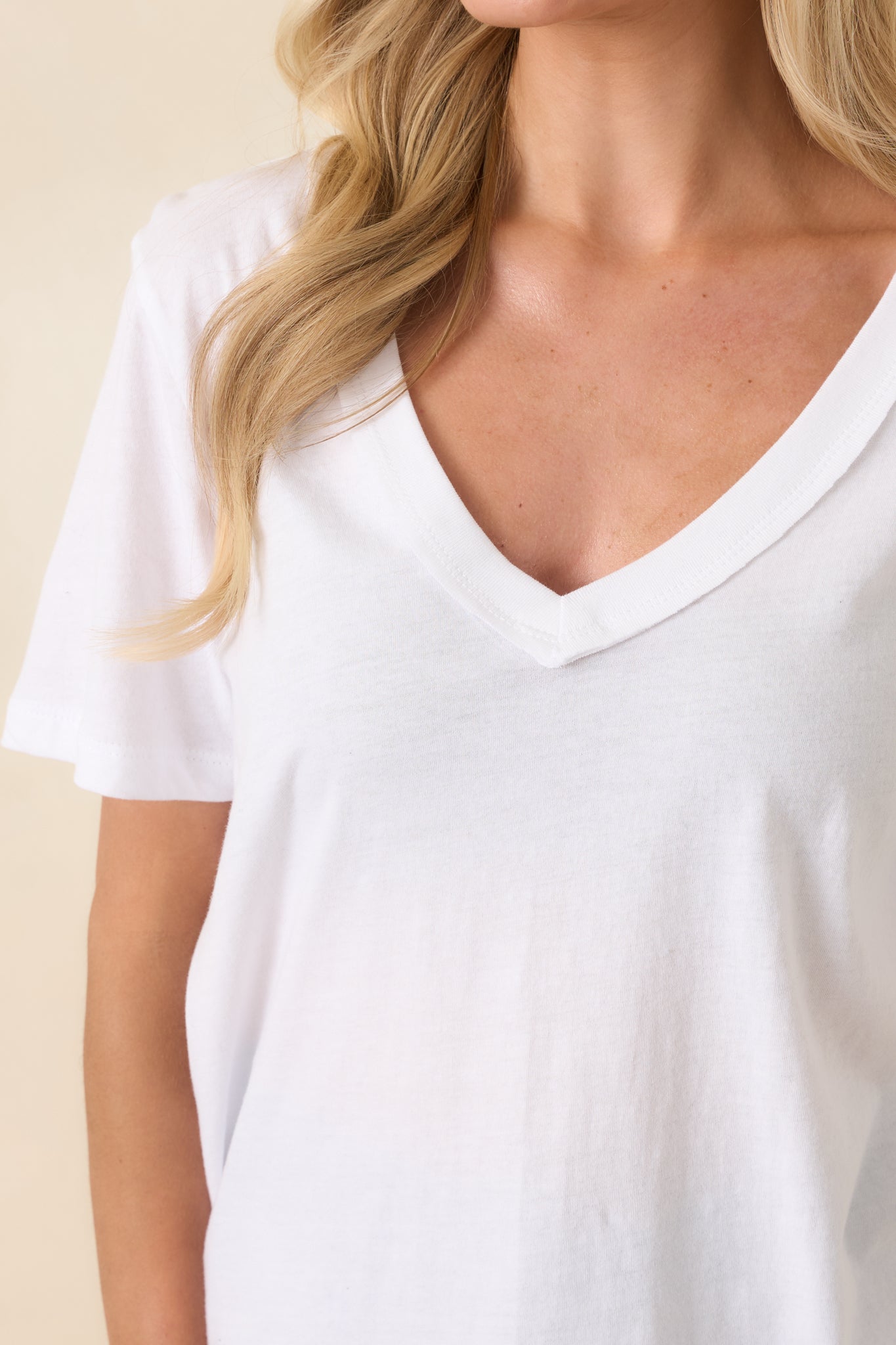 Close-up of the breathable knit texture, clean seam detailing, and gently curved hem for subtle refinement.