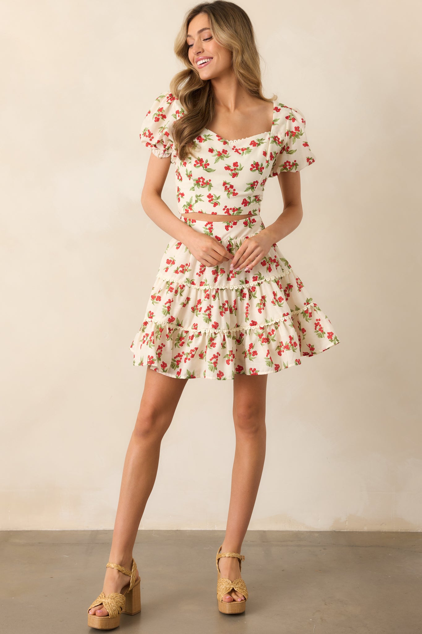 A breezy and feminine ivory top with a sweetheart neckline, short puff sleeves, and a fully smocked back for a comfortable, snug fit.