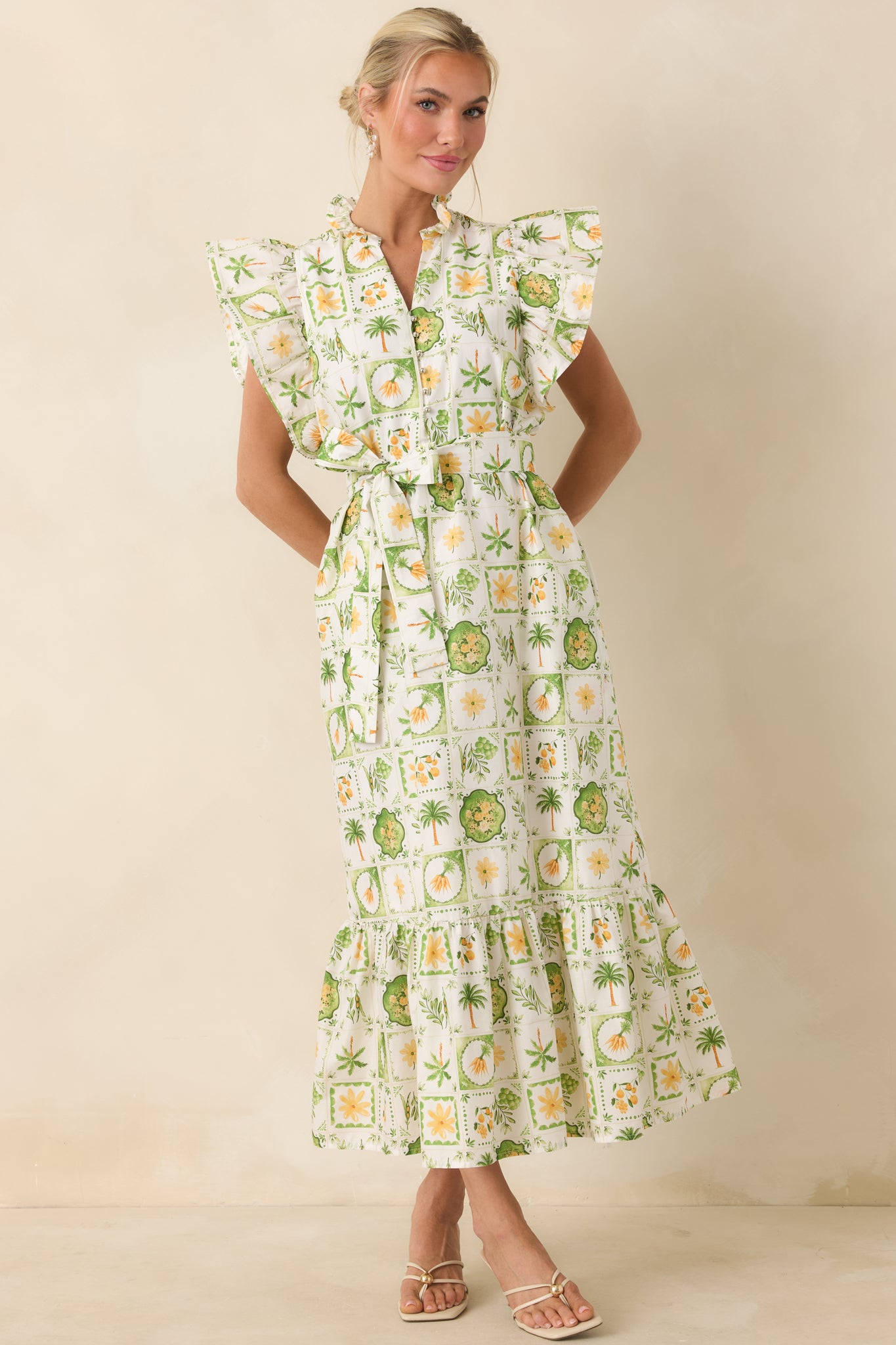 Breezy maxi dress with tiered skirt, flutter sleeves, and convenient side pockets.
