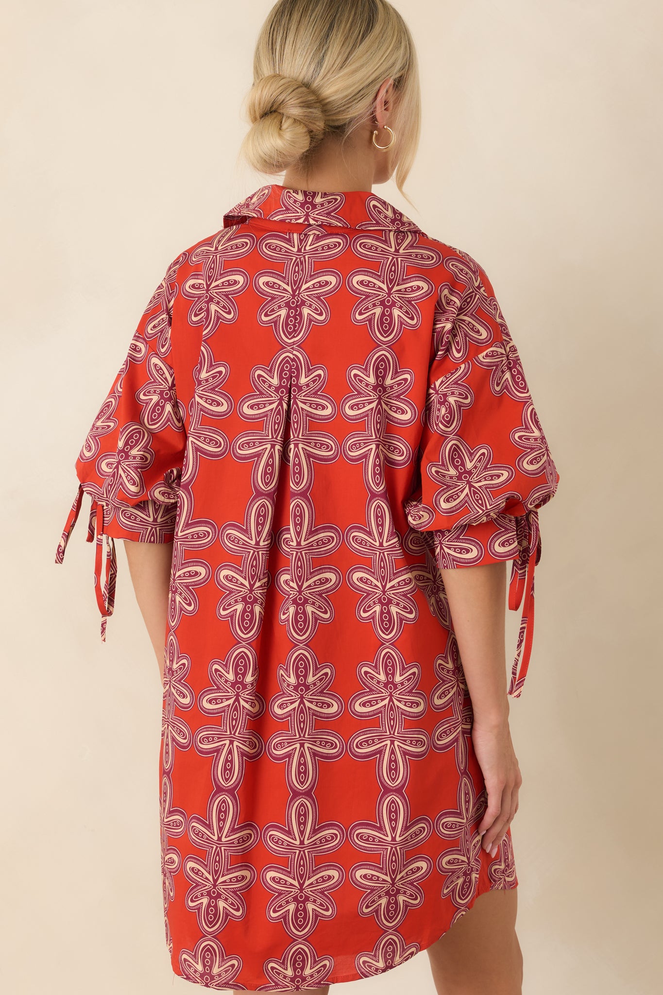 Back of the brick red and burgundy cotton mini dress featuring a relaxed silhouette and clean, fully lined finish.