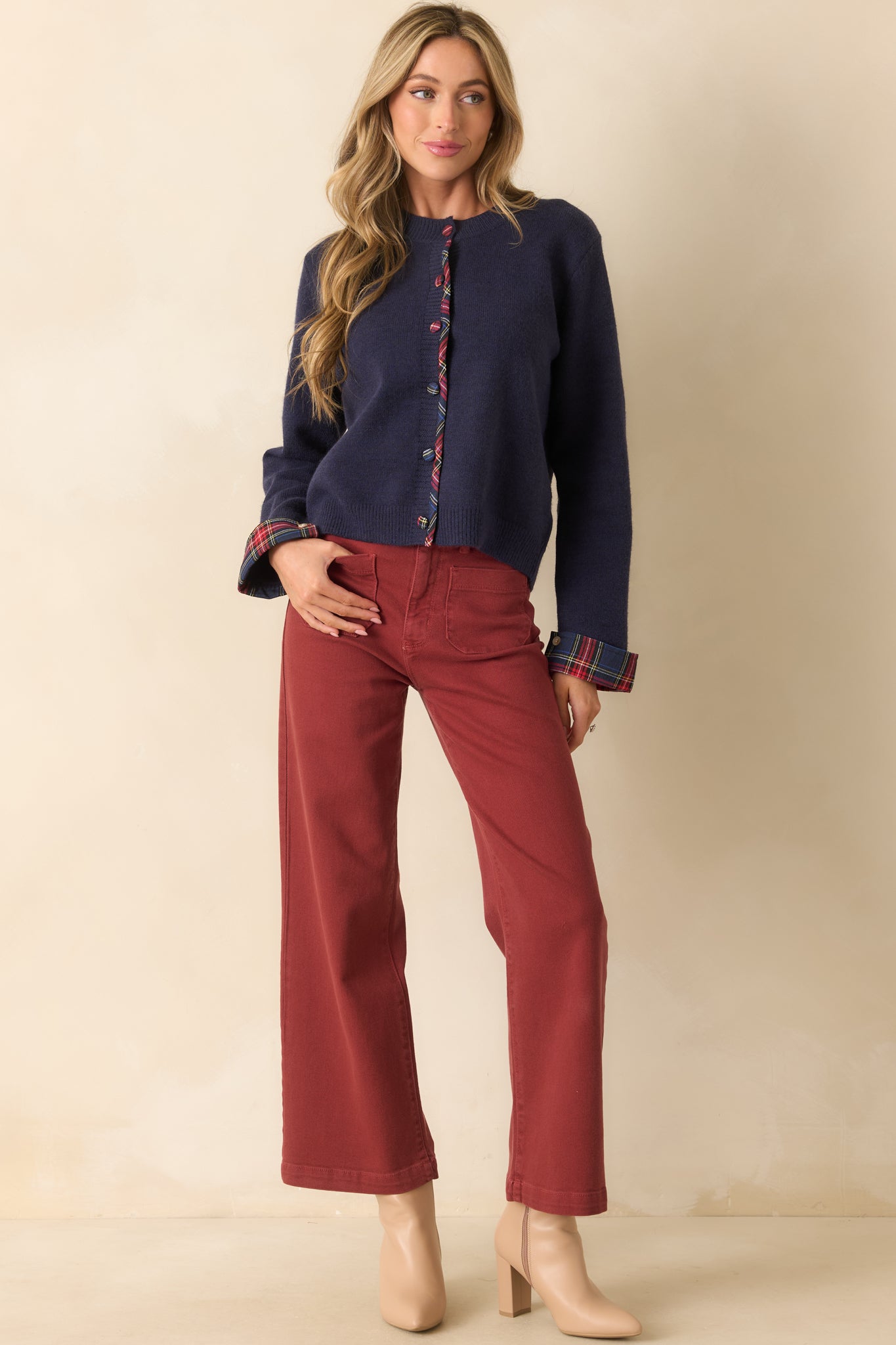 Wide-leg jeans in brick red featuring a zip fly with button closure and belt loops at the waist.