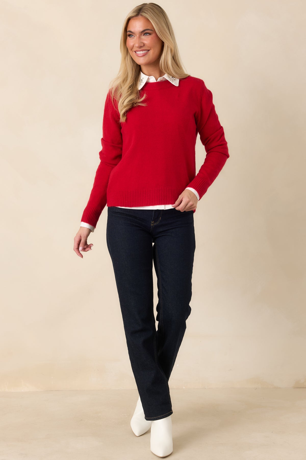 Bright red long-sleeve knit top featuring a classic neckline and softly relaxed silhouette.