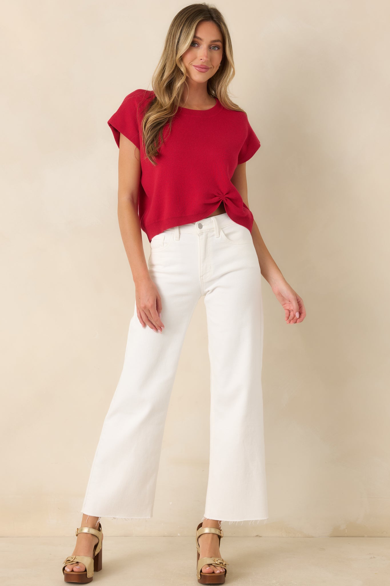 Bright red knit sweater featuring a relaxed fit, cap sleeves, and a softly cinched front detail for added dimension.