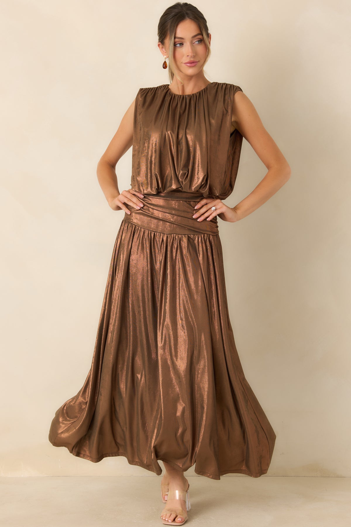 Bronze maxi skirt with a coppery shimmer, wide ruched waistband, and flowing full-length silhouette.