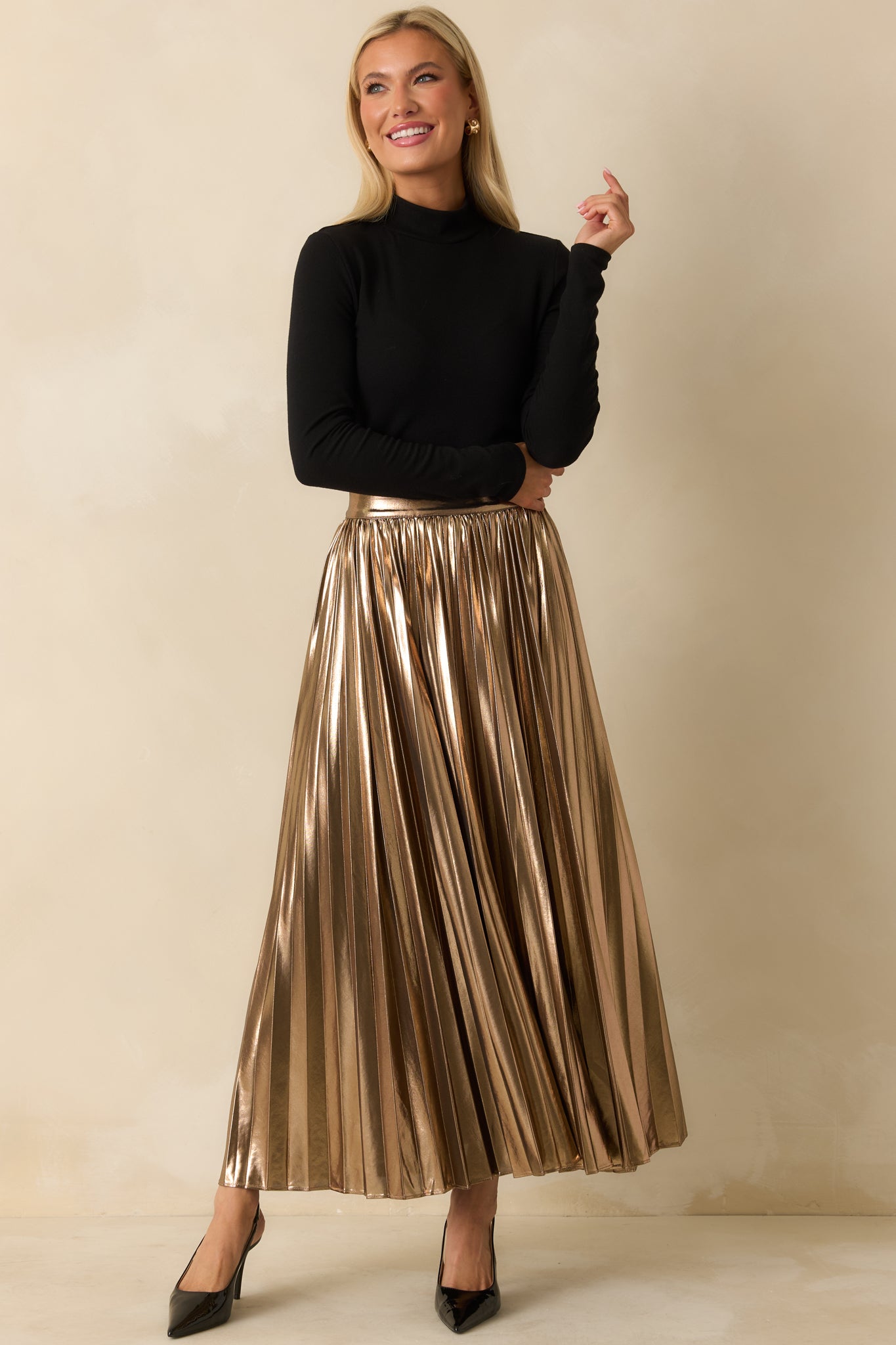 Flowing bronze metallic skirt with a fully pleated silhouette, flat front waistband, and elegant movement.