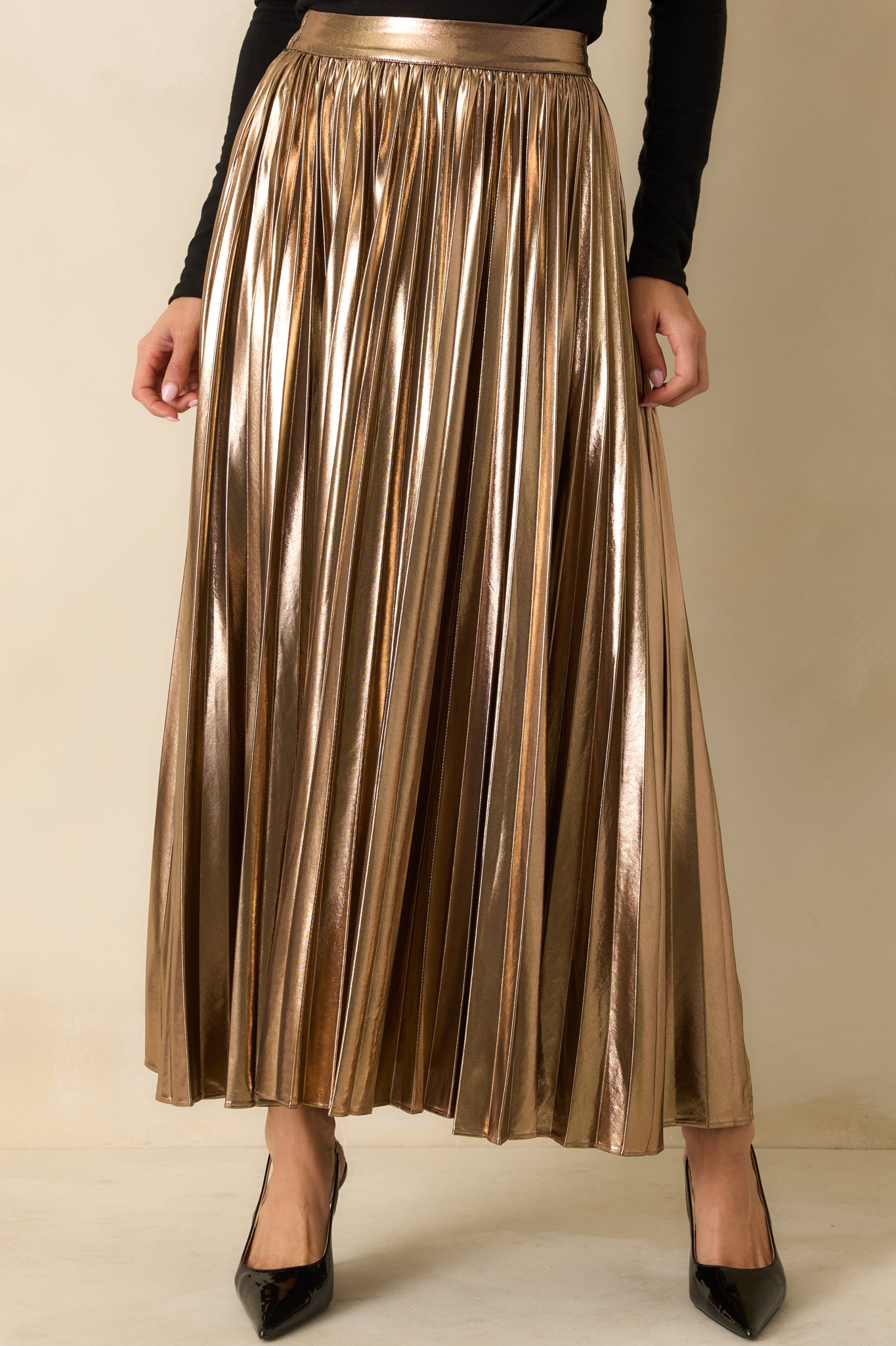 Front-focused detail showing the smooth flat waistband and shimmering pleated texture.