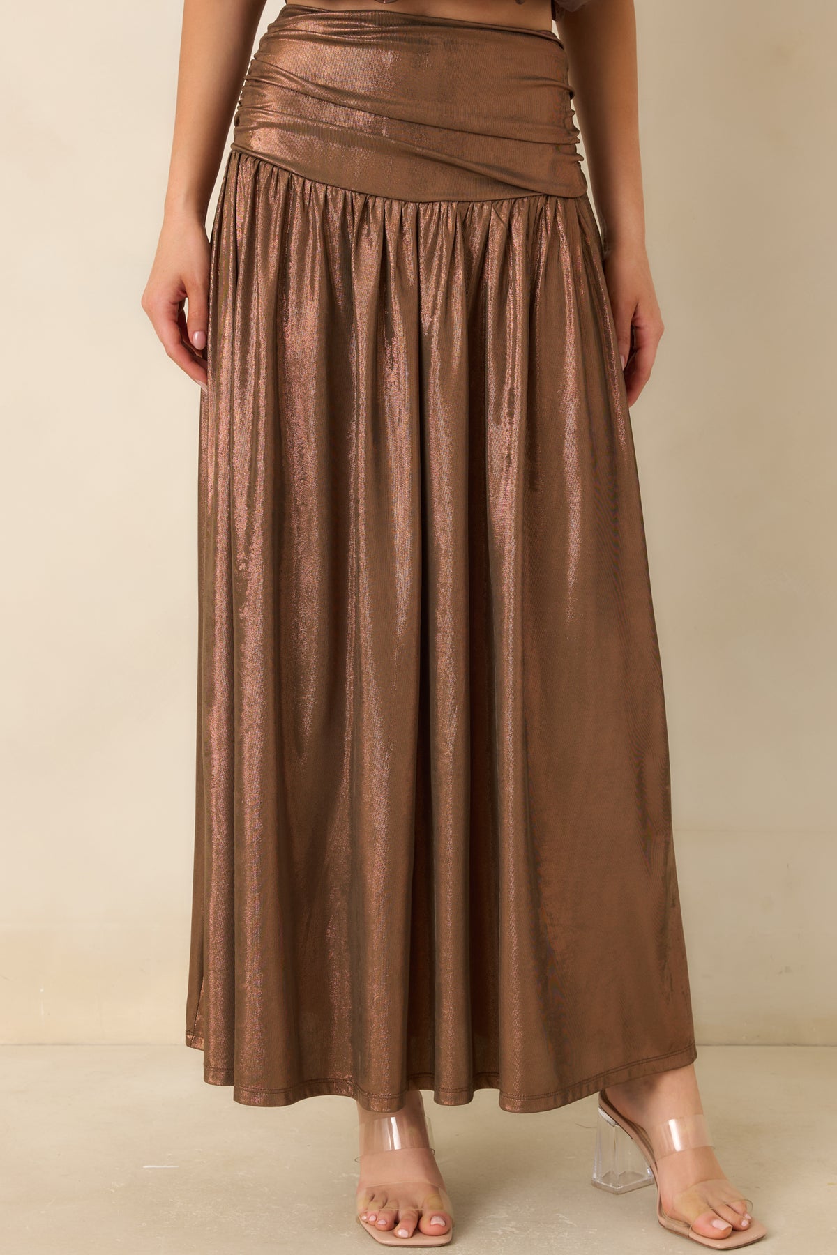 Wide ruched waistband shapes the bronze skirt through the upper hips with a softly textured finish.