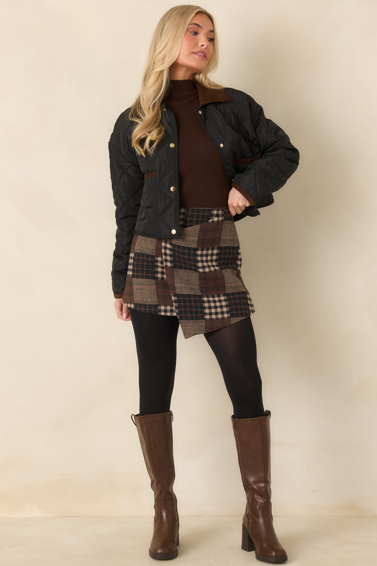 Patchwork mini skirt combining chocolate brown, black, and beige plaids with fine rust-colored lines.