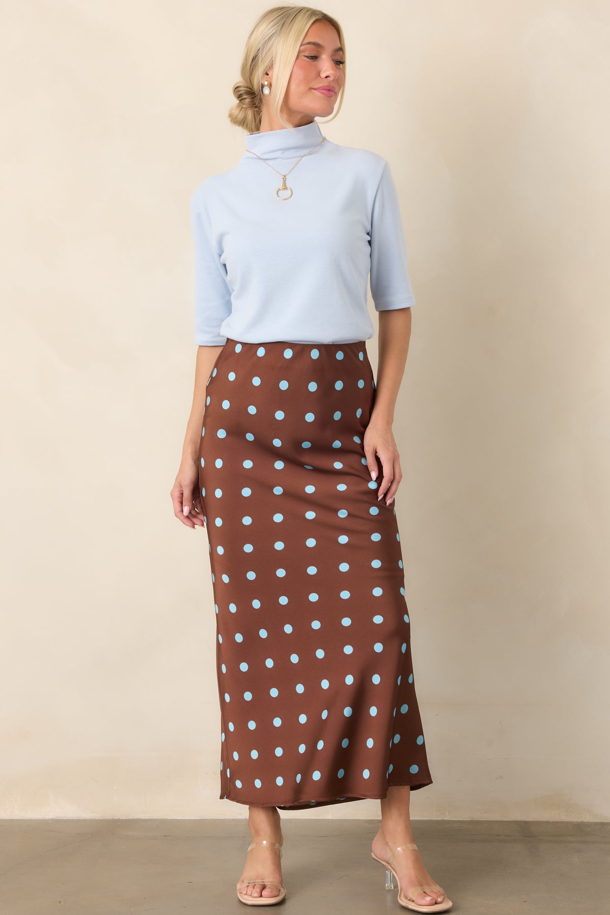 Silky satin skirt showcasing a vintage-inspired chocolate brown and light blue polka dot print with an elegant fluid drape.