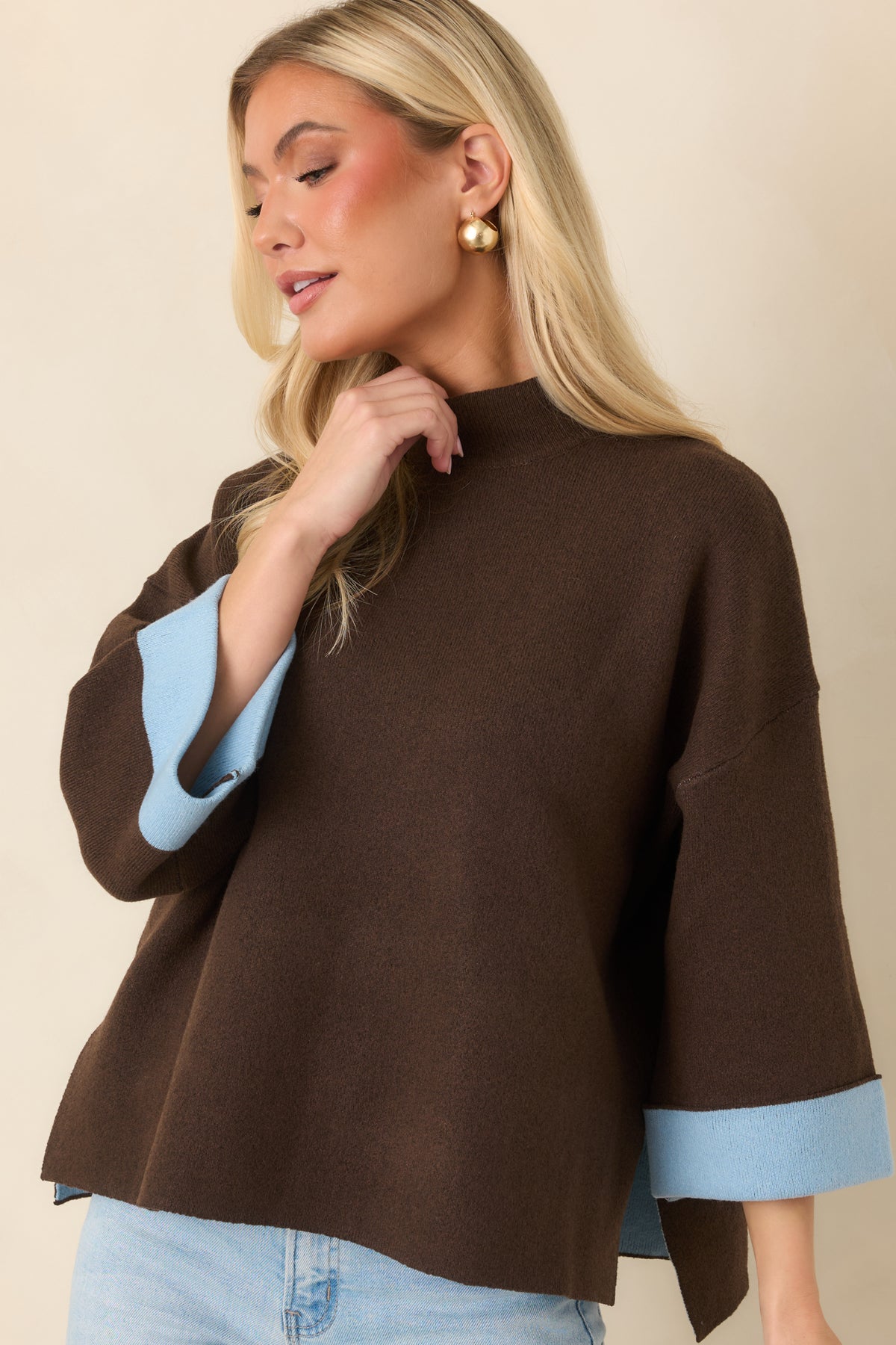 Rich brown knit top featuring a loose boxy fit and side slits at the hem.