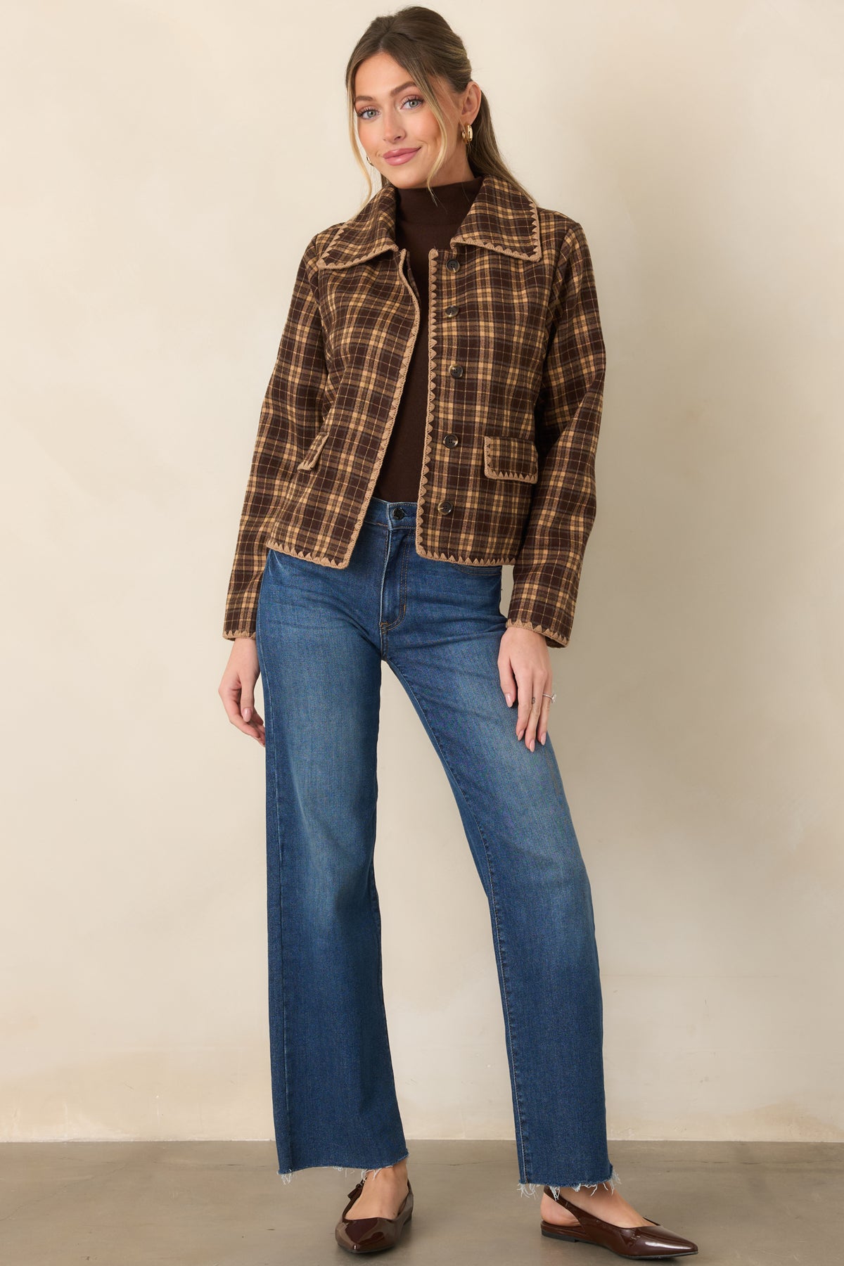 Brown and camel plaid jacket showcasing a boxy shape, collared neckline, scalloped trim, and tonal front buttons.