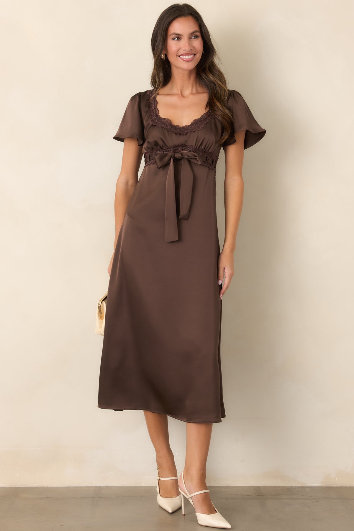 Brown dress with short flutter sleeves and a softly gathered satin bodice.