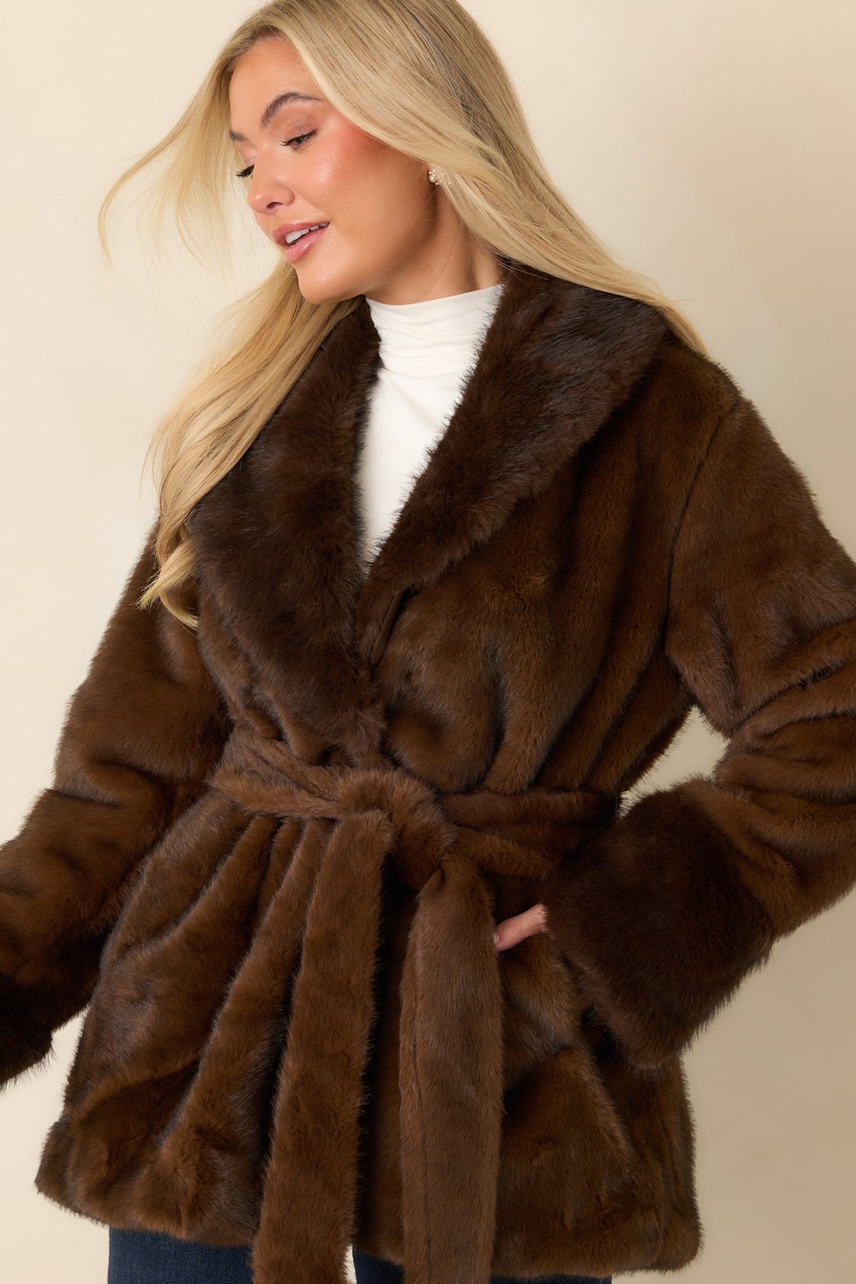 Rich brown coat featuring a matching self-tie belt that defines the waist.