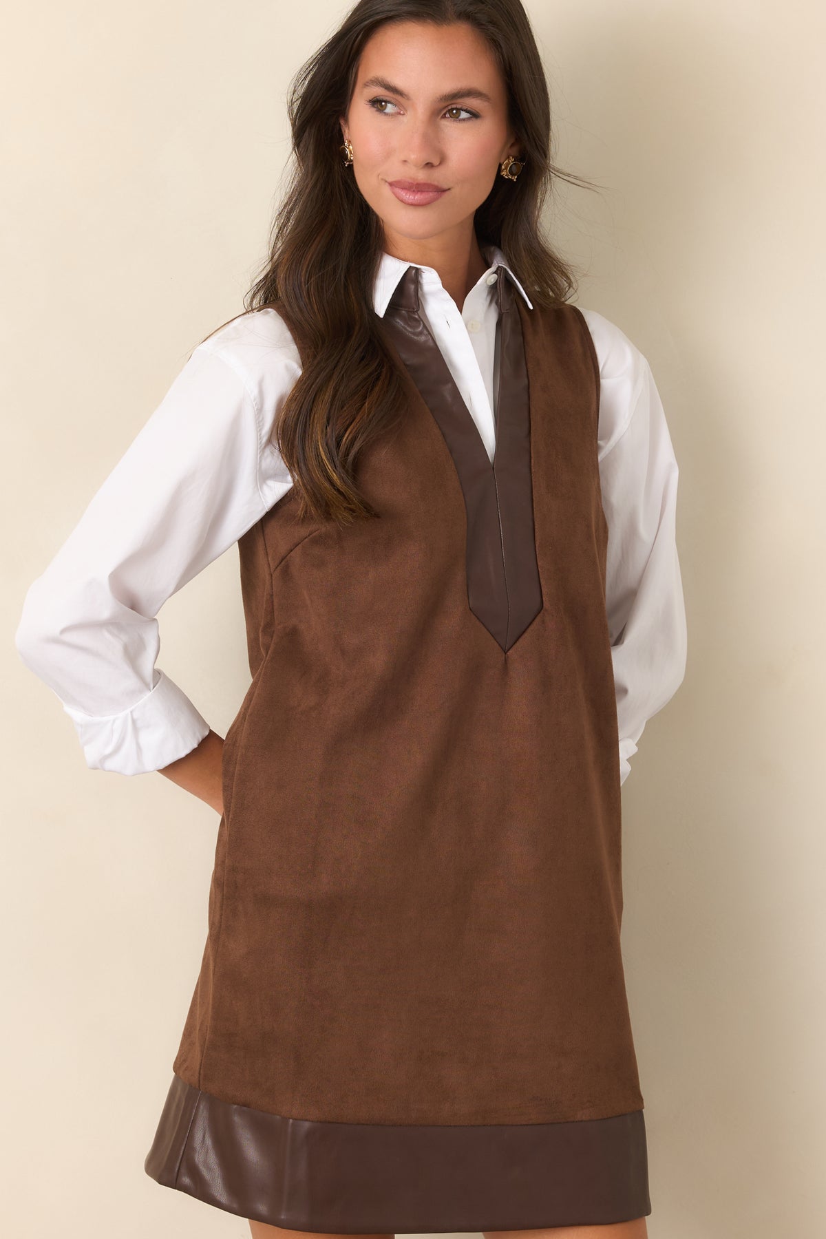 Brown faux suede dress highlighting the deep V-neckline and smooth faux leather trim.