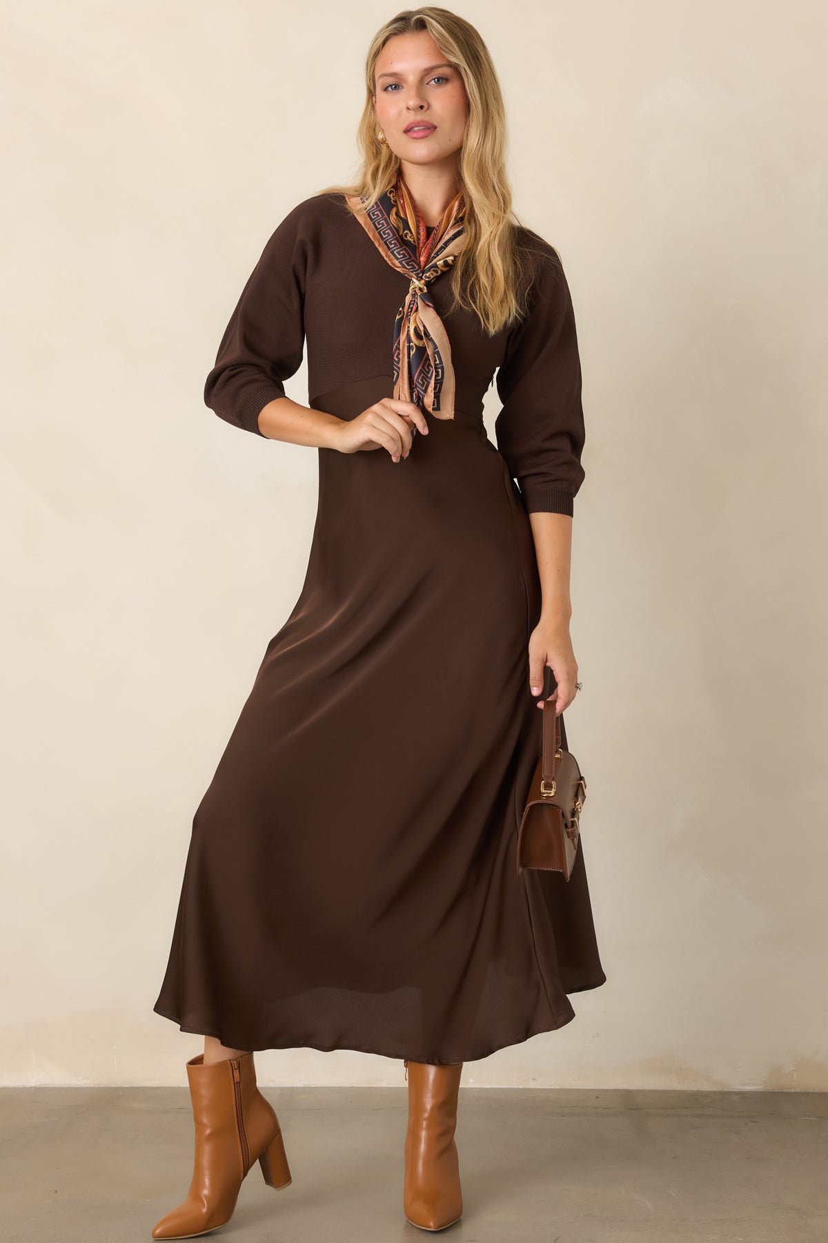 Fitted knit bodice meets a high-waisted satin skirt in this brown midi dress with a flowing A-line silhouette.