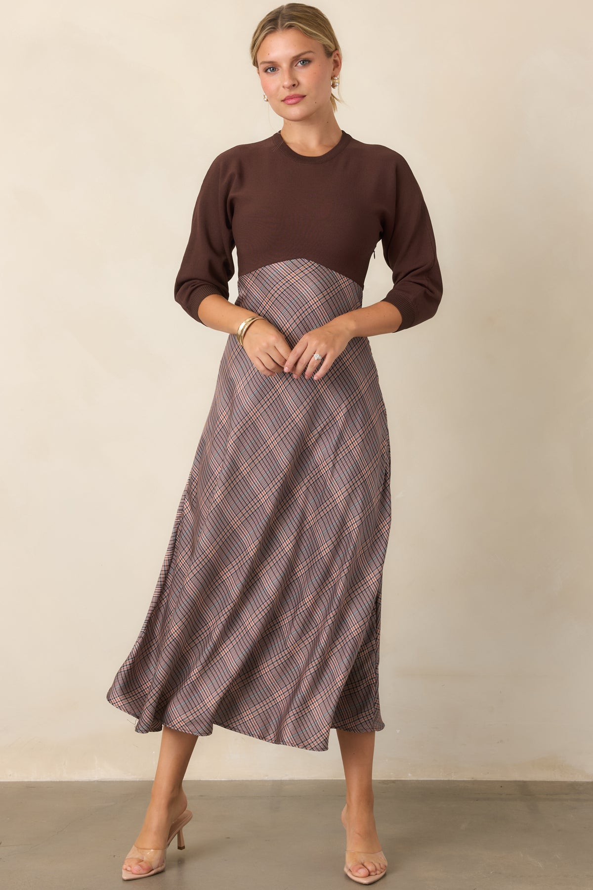Brown fitted knit dress with a classic round neckline and three-quarter sleeves in a sleek silhouette.