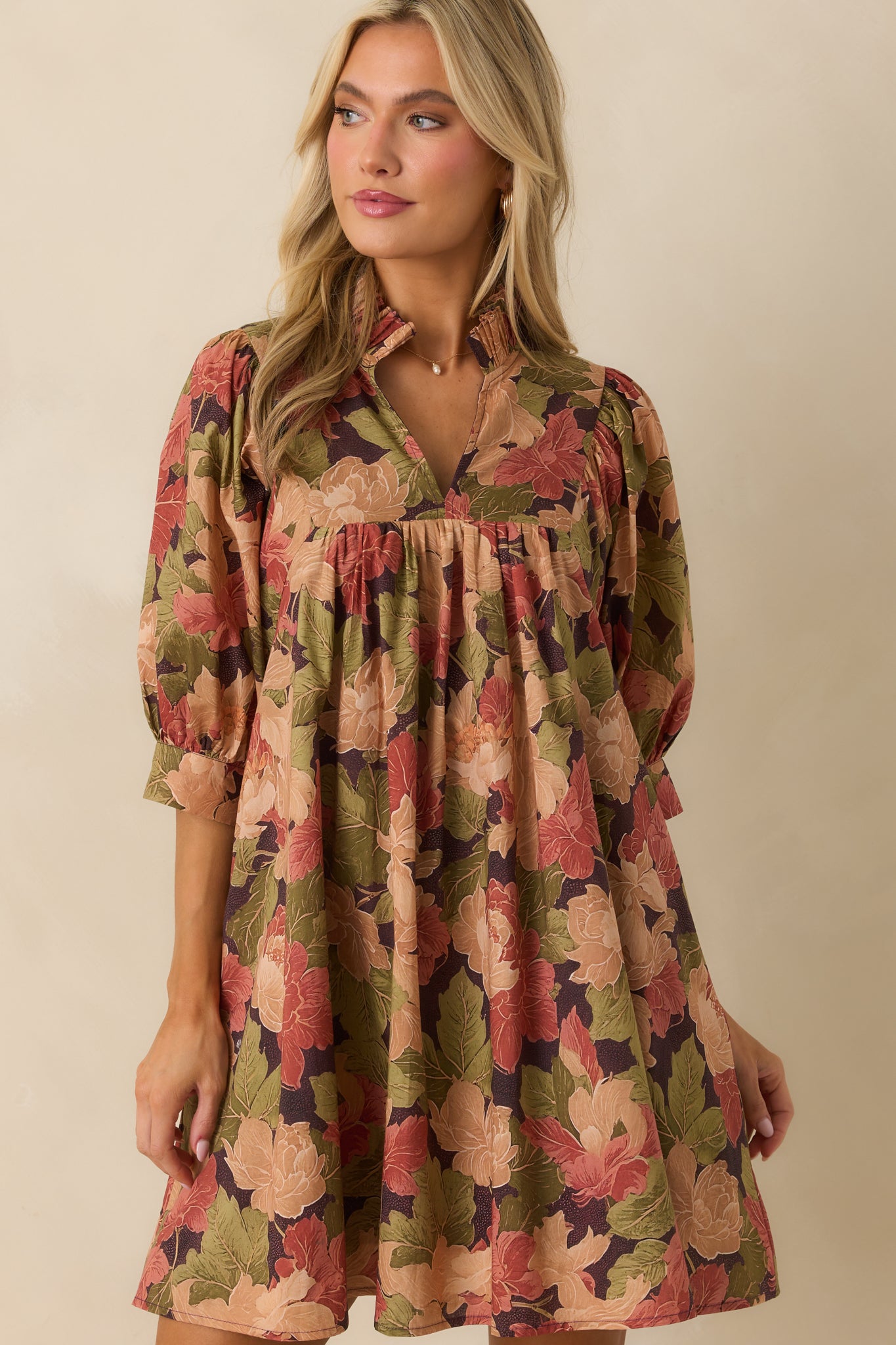 Split v-neckline with delicate ruffle trim on the brown floral dress.