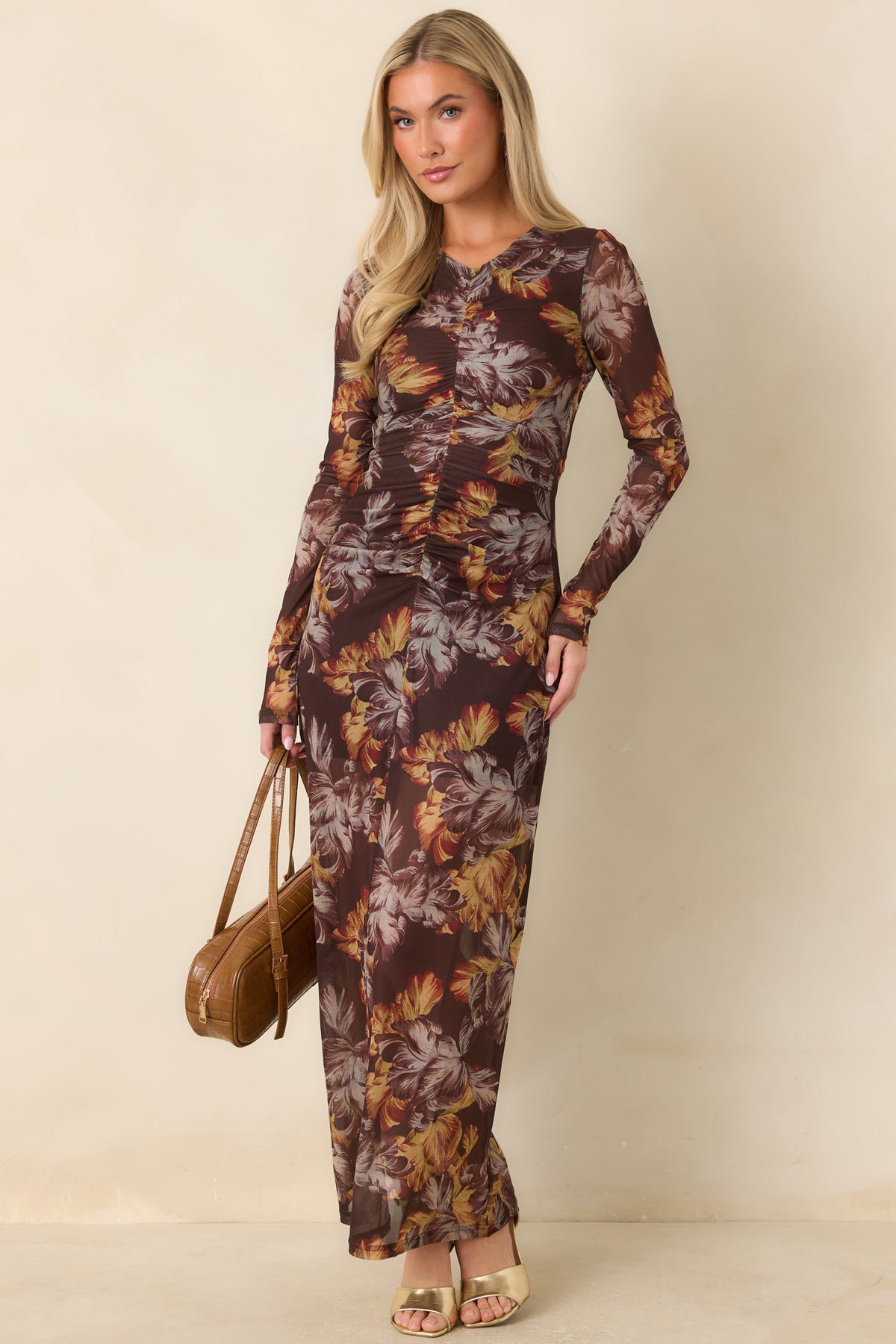 Floral mesh dress featuring golden ochre, rust, and taupe flowers against a deep brown background.