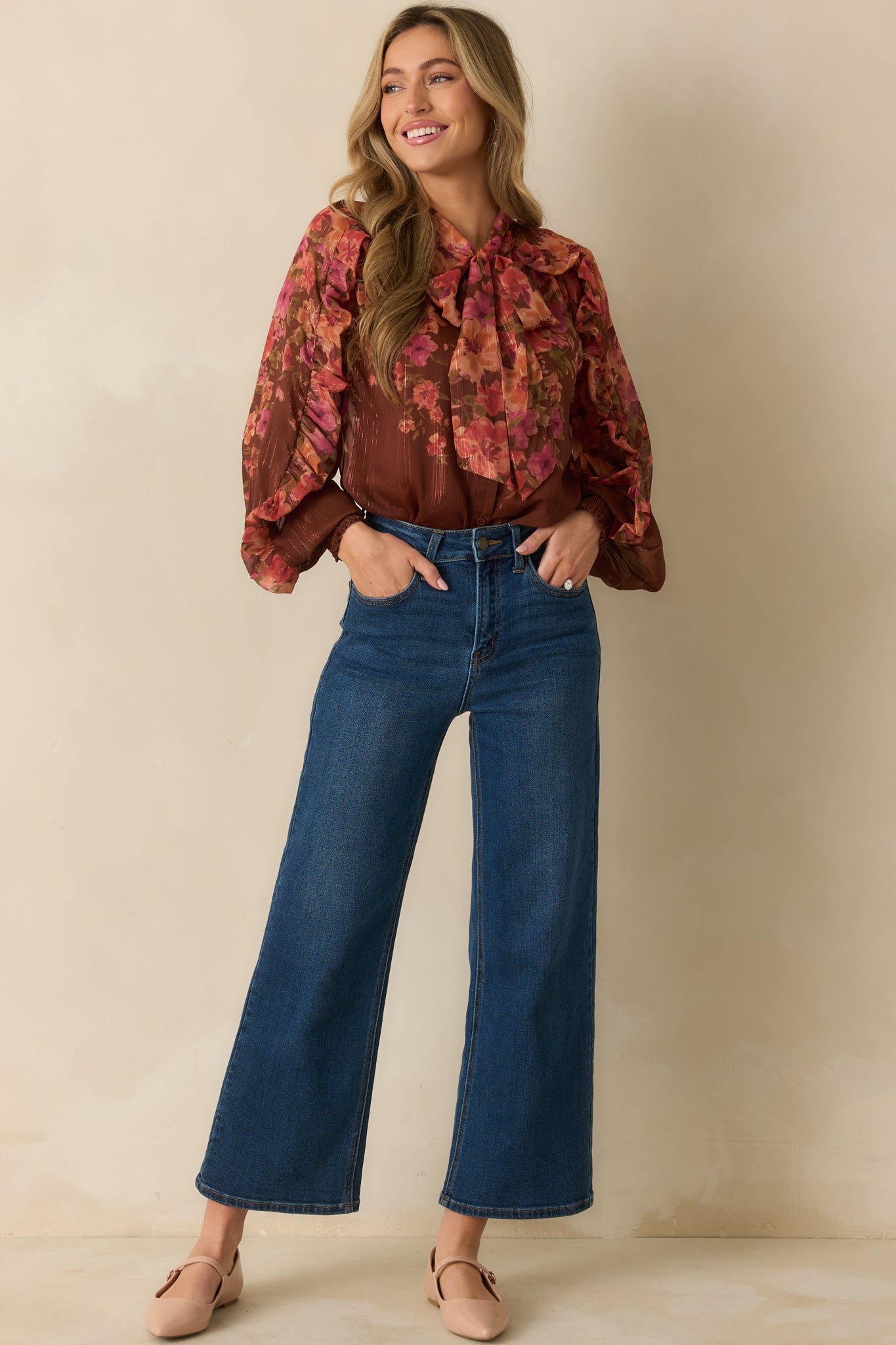 Brown floral print top featuring self-tie neck, long sleeves, and delicate ruffle accents for a feminine look.