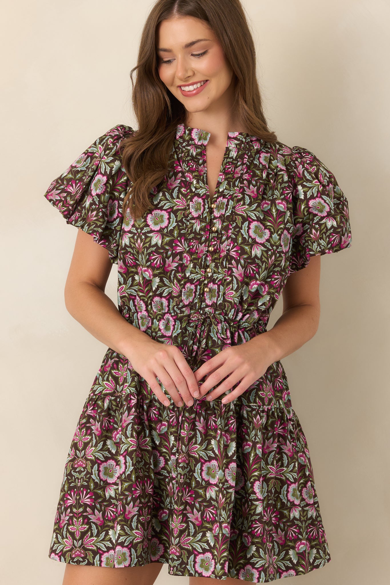 Vibrant fuchsia, olive, and sage florals create a striking pattern across the rich brown fabric.