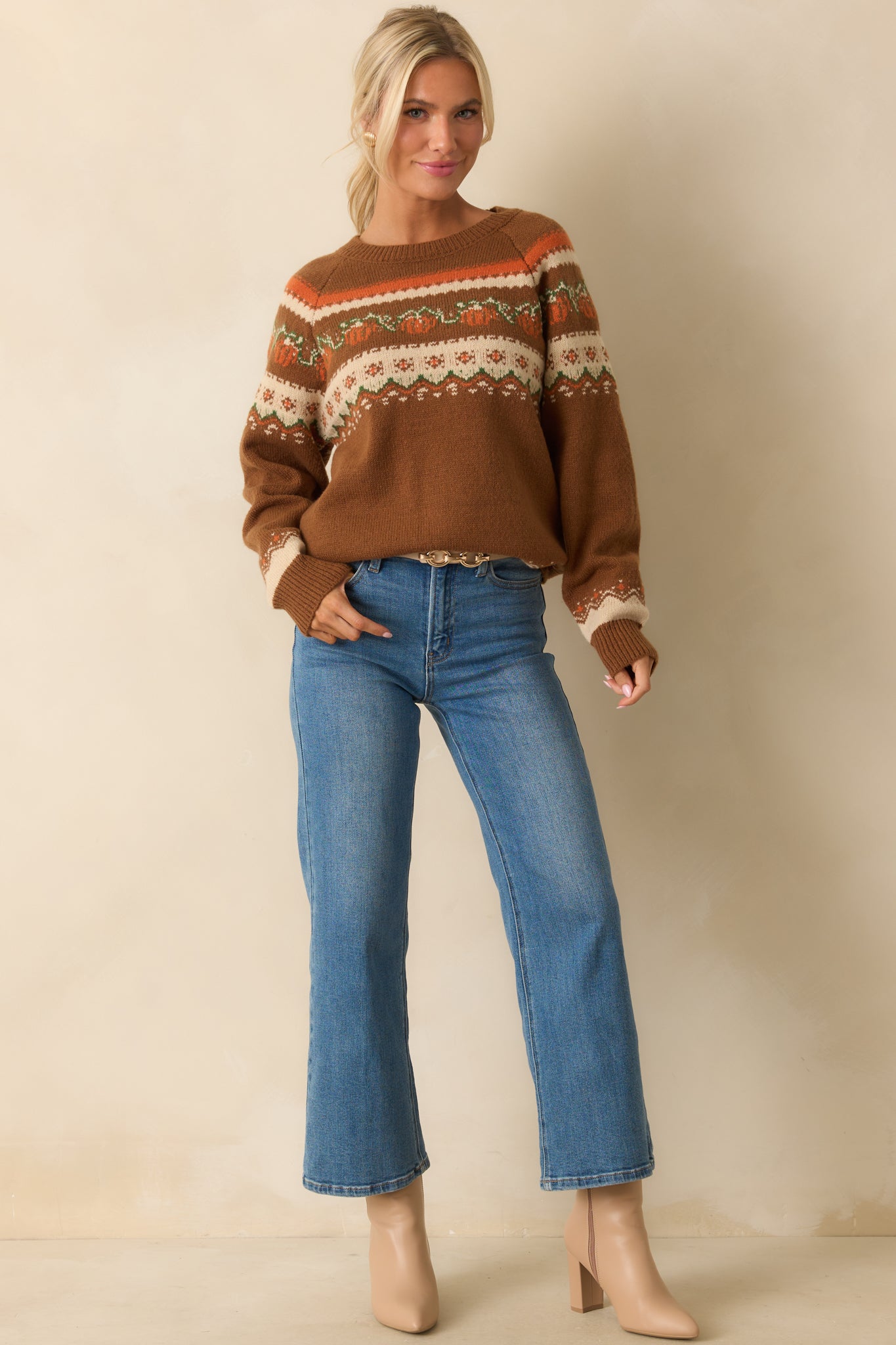 Brown knit sweater with a multicolor pumpkin and floral fair isle pattern, ribbed hem and cuffs, shown in a relaxed front view.