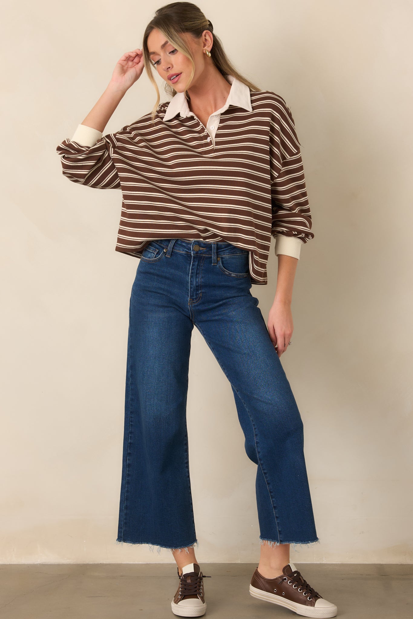 Rich brown knit top featuring horizontal ivory stripes, an oversized contrast collar, dropped shoulders, and long sleeves.
