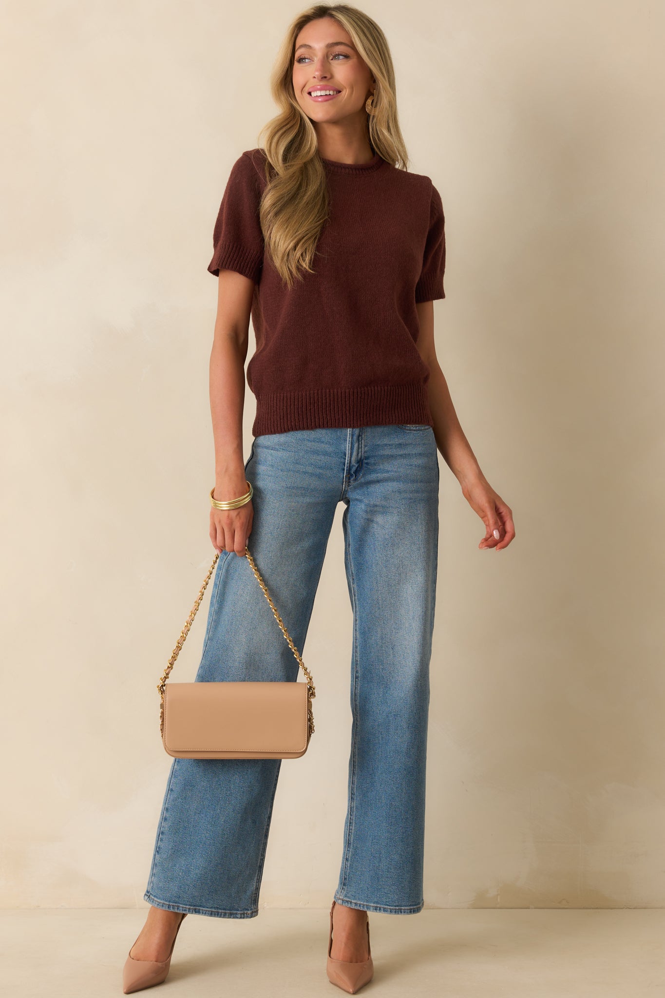 Brown knit top with rolled hem crew neckline and short sleeves.