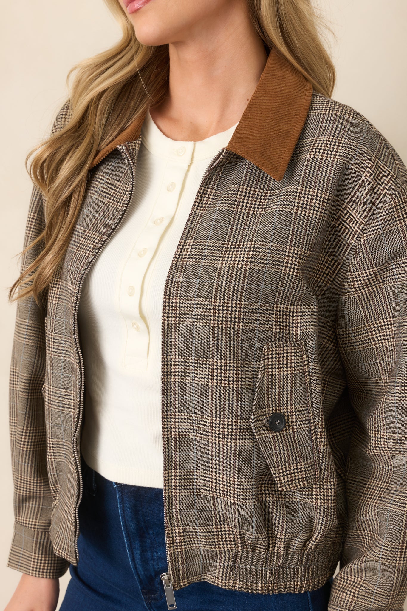 Close-up of the brown multi-plaid woven fabric and contrasting corduroy collar, showcasing the jacket's textured construction.