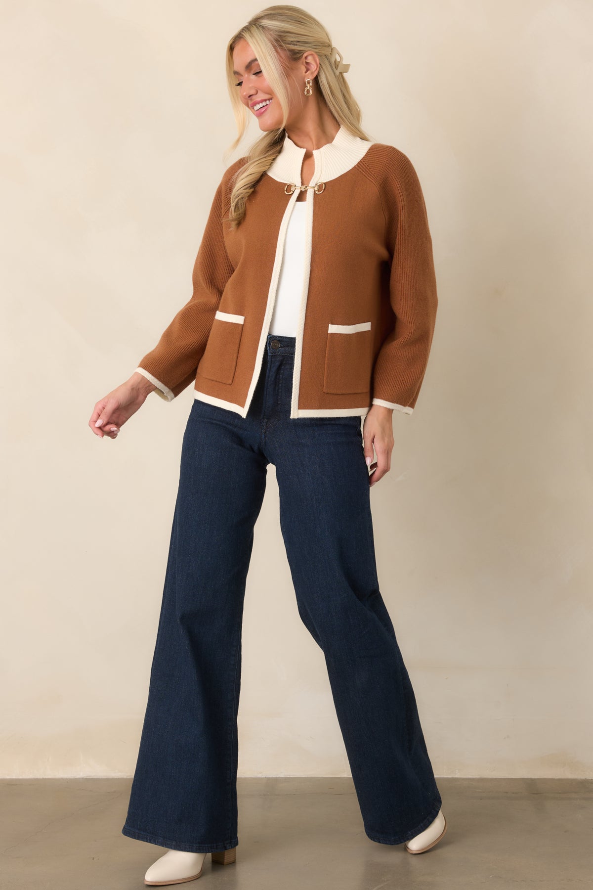 Brown open-front cardigan with ivory trim, ribbed cuffs and hem, and functional patch pockets.