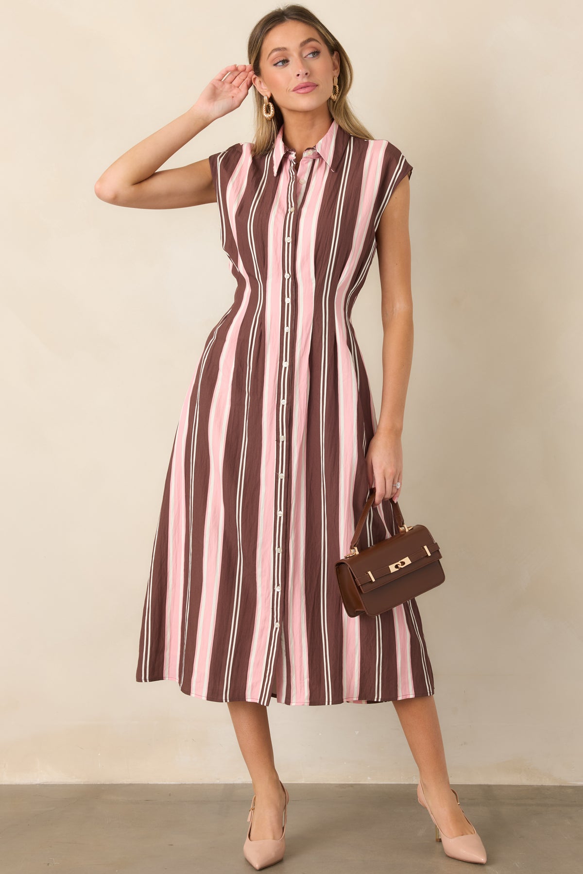 Soft brown, blush pink, and ivory striped midi dress featuring a classic collared neckline, full button-front closure, cap sleeves, and a flattering fit-and-flare silhouette.