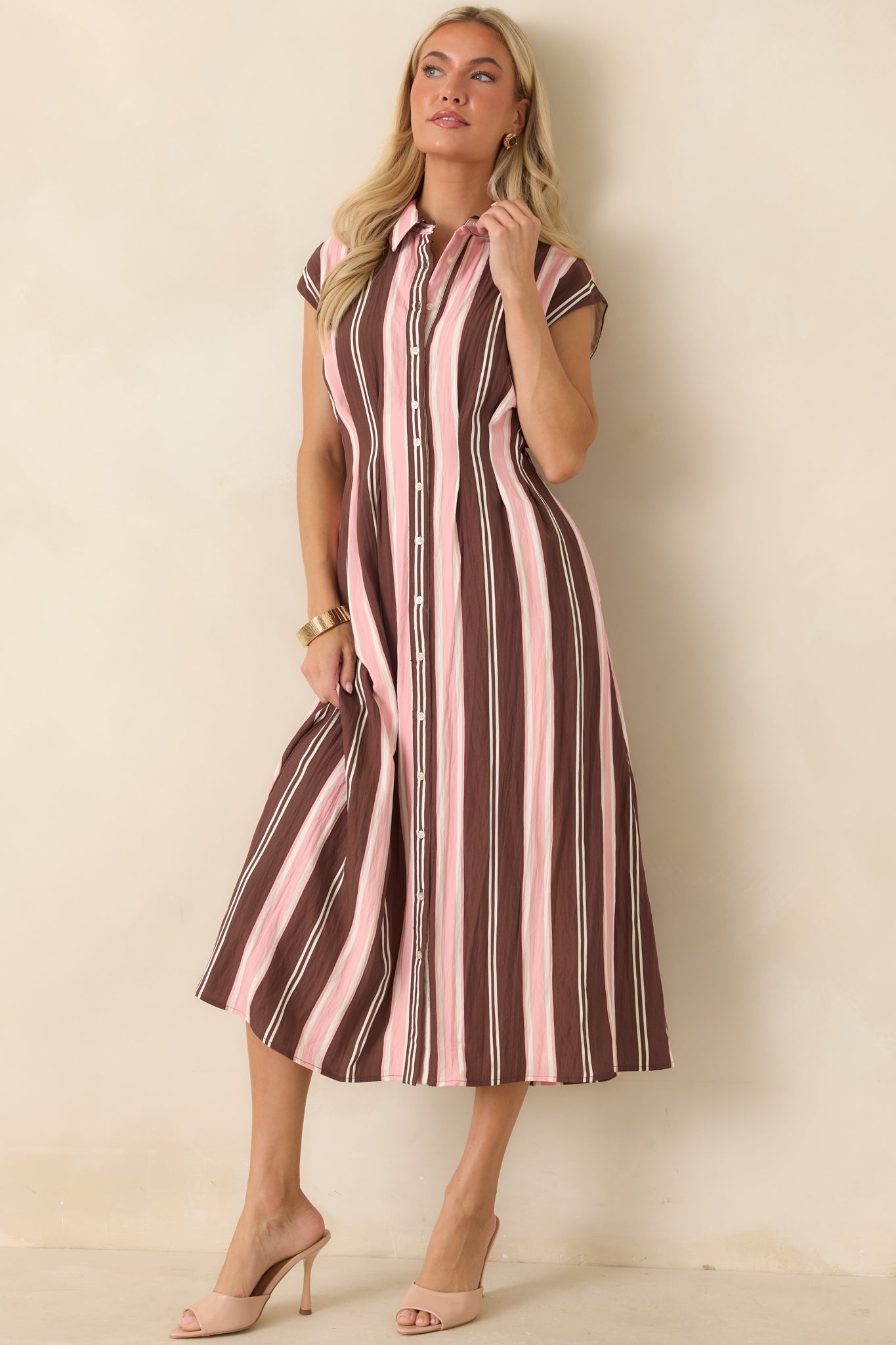 Striped fit-and-flare midi dress featuring a collared neckline, button-front design, cap sleeves, and side pockets.