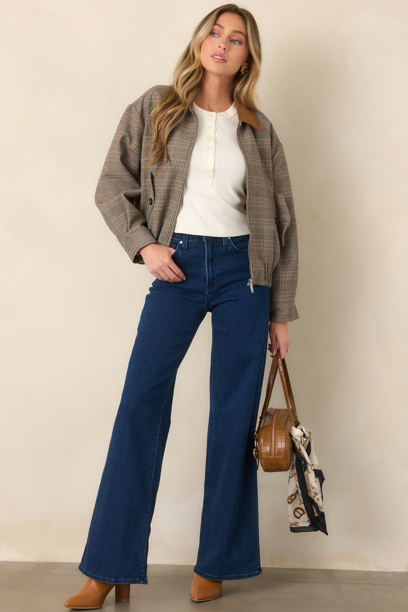 Plaid bomber jacket featuring mixed brown tones, a soft corduroy collar, buttoned flap pockets, and a relaxed shape finished with an elastic hem.
