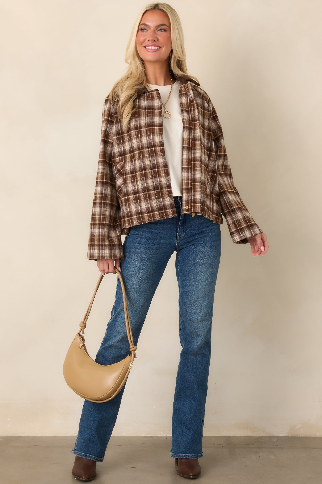 Brown plaid jacket with a soft corduroy collar, zip-front closure, long sleeves, functional side pockets, and relaxed boxy silhouette.