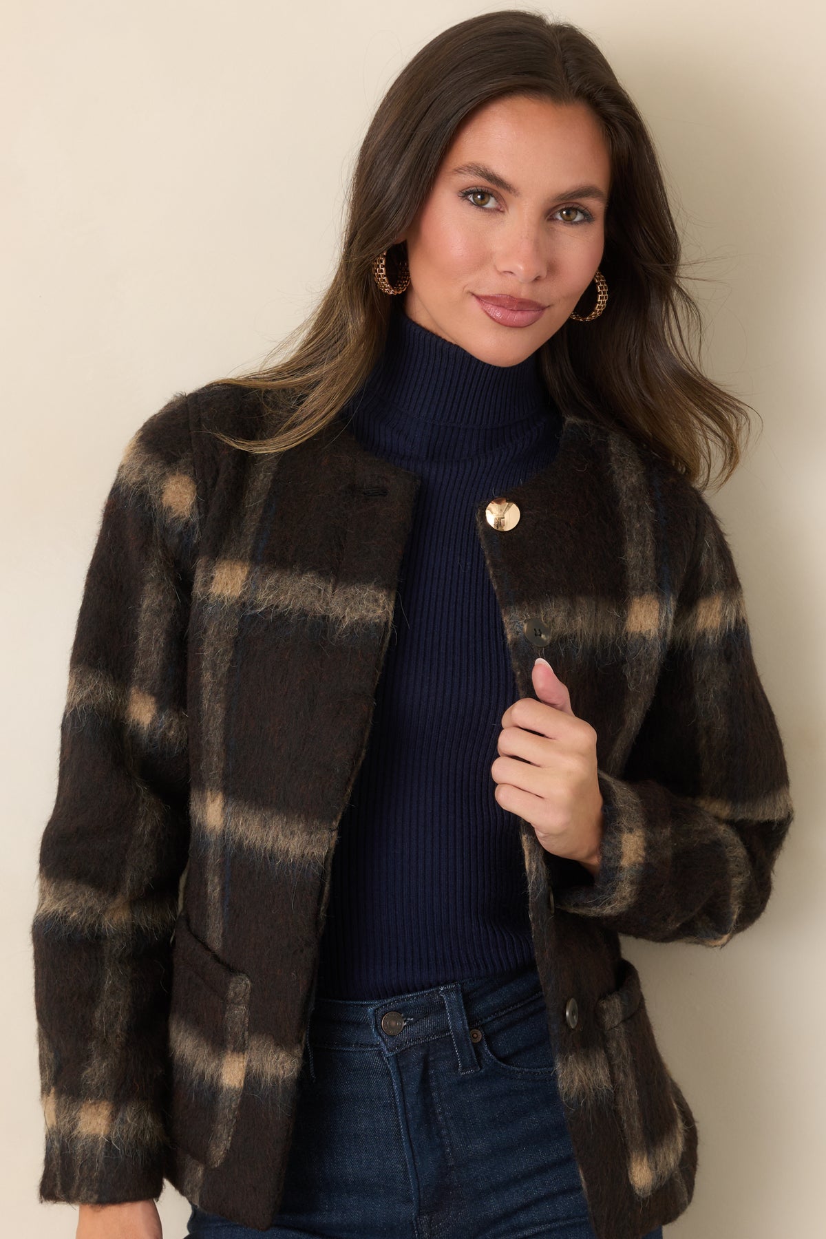 Collarless brown plaid jacket featuring a distinctive gold-tone top button above the concealed front closure.