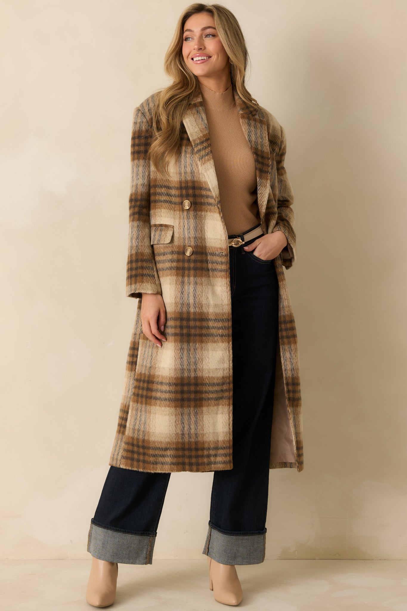 Brown plaid wool-blend overcoat worn buttoned, emphasizing its refined double-breasted style and streamlined longline fit.
