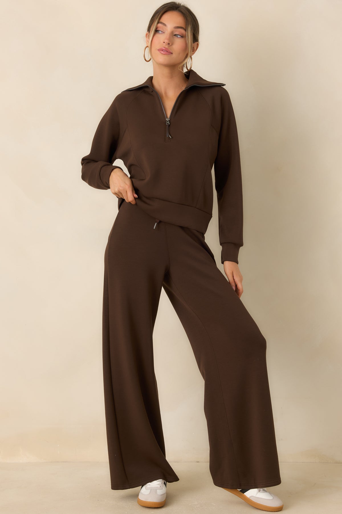 Brown pull-on pants featuring a smooth waistband and a flowing wide-leg silhouette.