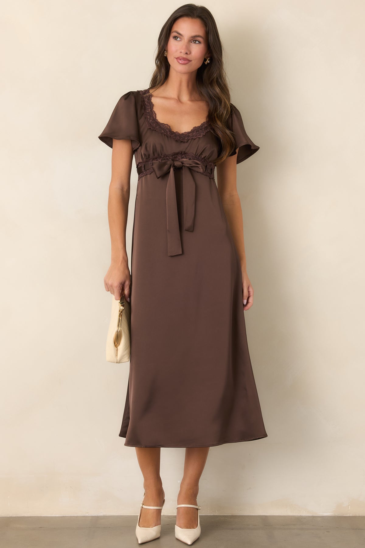 Brown satin dress with a defined bodice flowing into a softly flared midi skirt.