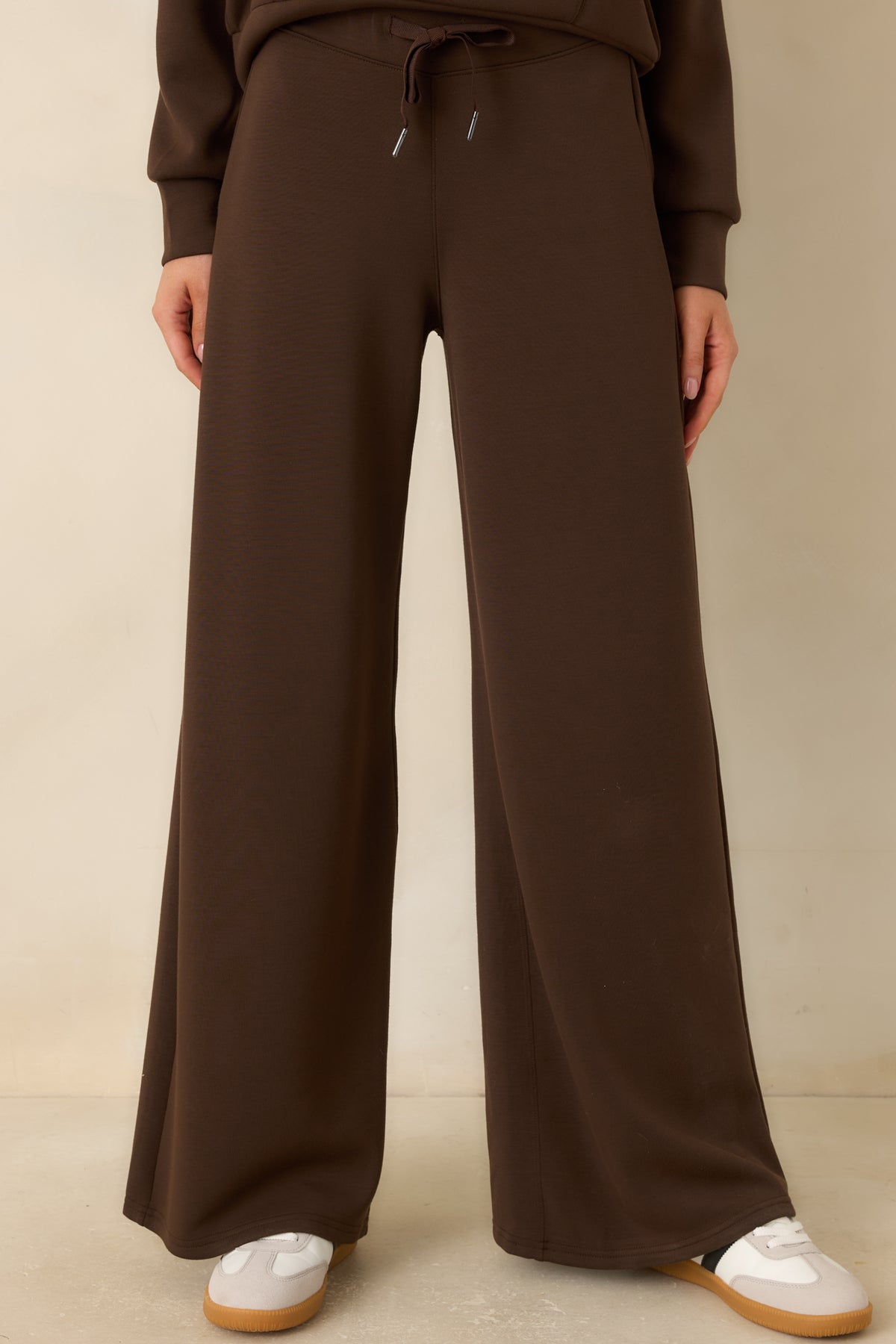 Lush brown spacer fabric pants showcasing their relaxed fit through the hips and wide legs.
