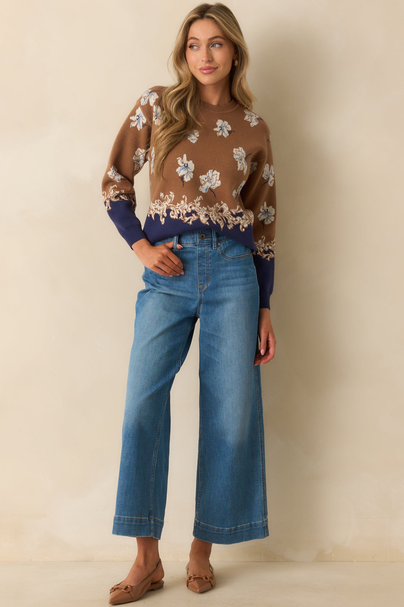Brown sweater styled with blue floral jacquard knit design and navy border hem.